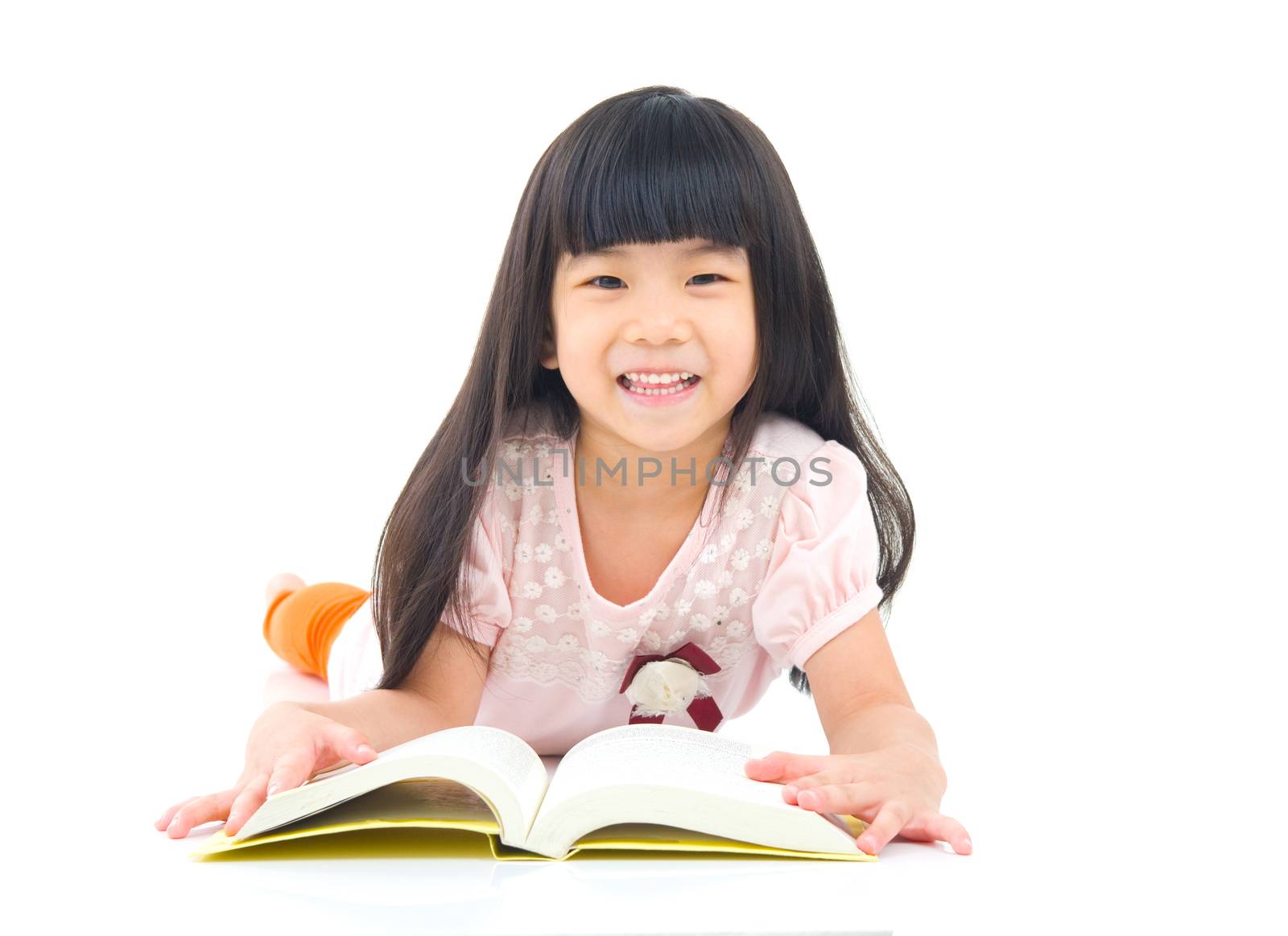 Asian girl lying on the floor and reading