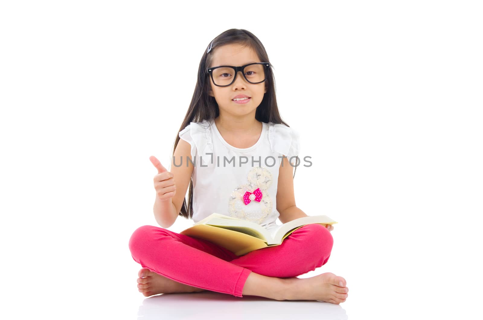 Asian girl wearing spectacles sitting on the floor with books