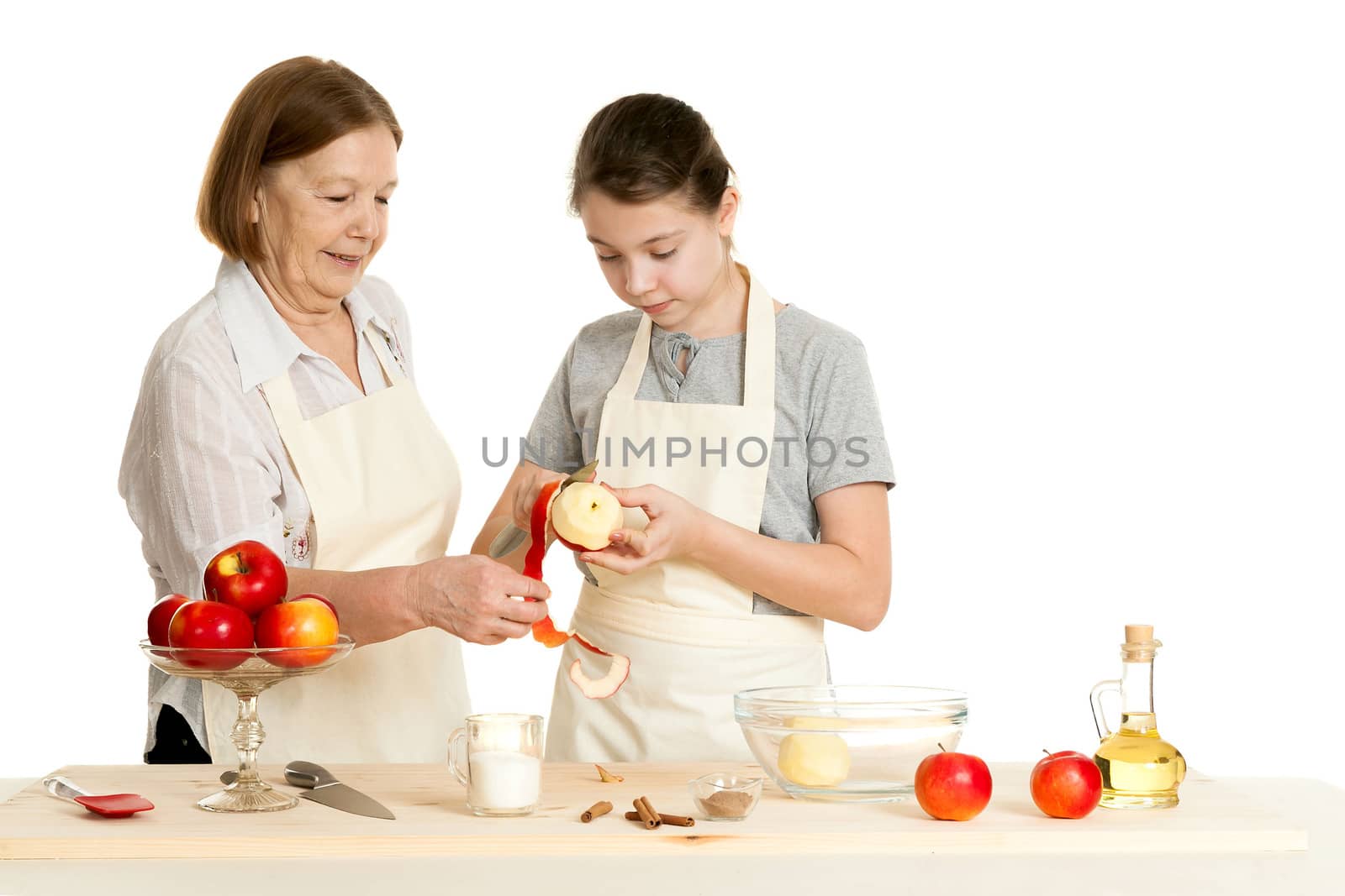 the grandmother and the granddaughter cut off a peel from apple by sveter