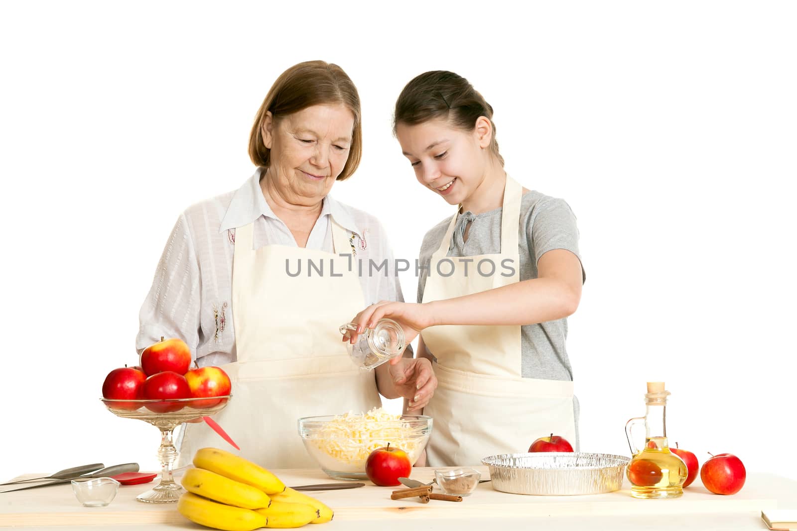 the grandmother and the granddaughter add ingredients to a plate