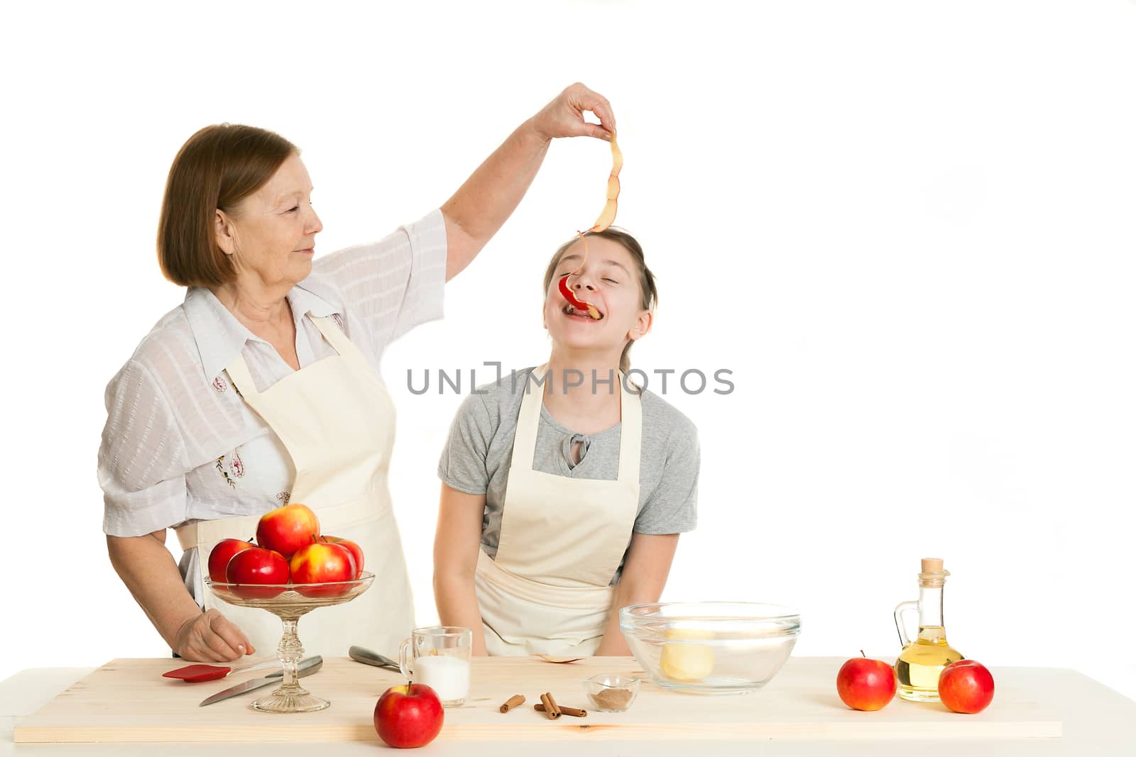 the grandmother treats the granddaughter with a peel from apple