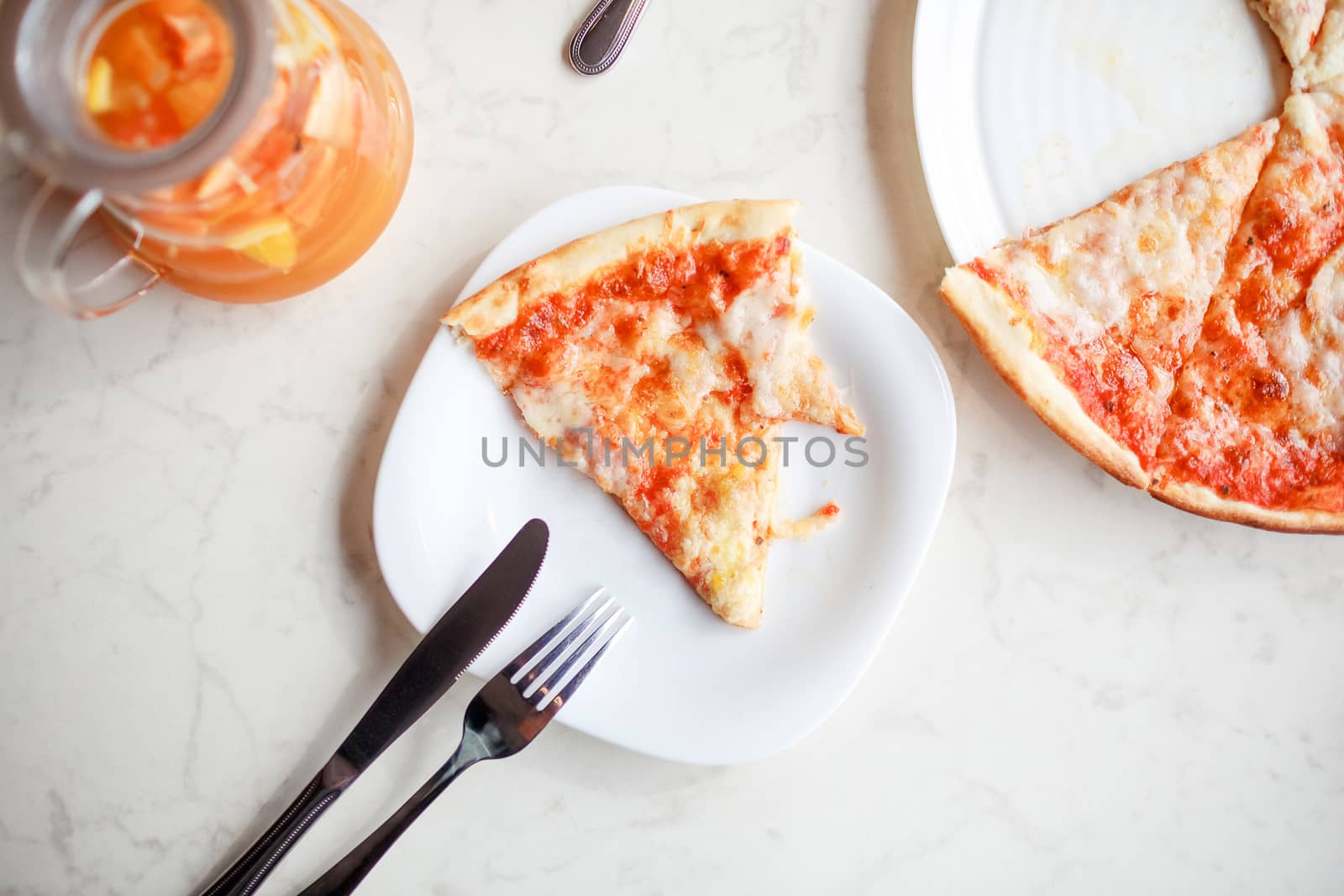 slice of pizza on a plate top view with fruit tea