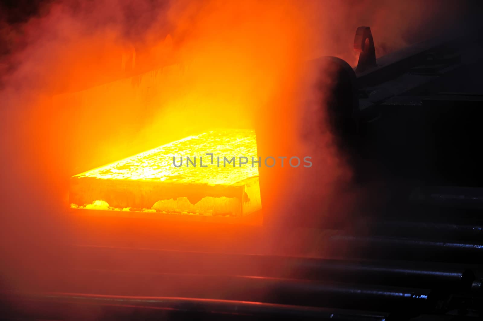 hot steel plate on conveyor in steel mill