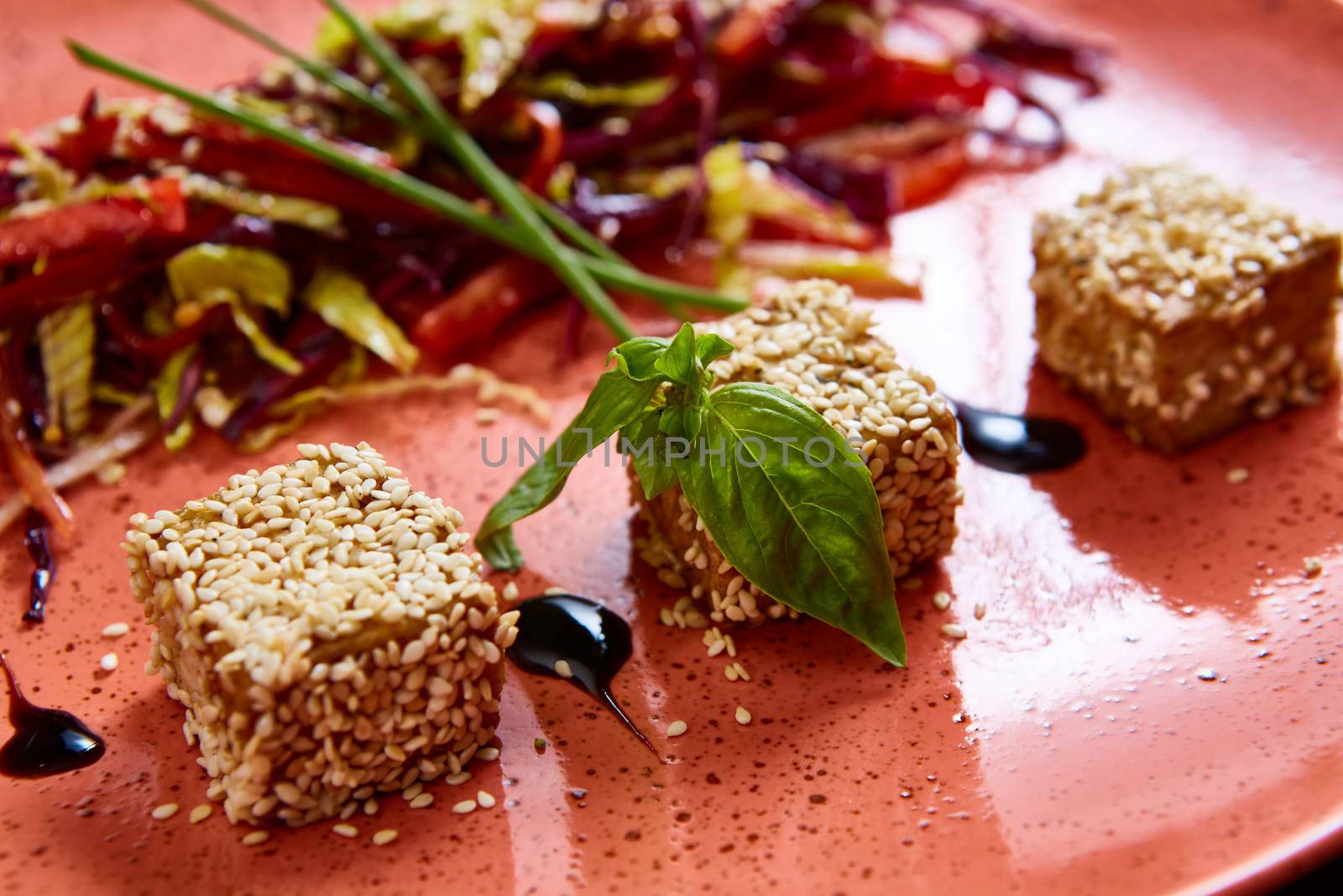 Stir fried tofu in a bowl with sesame and greens