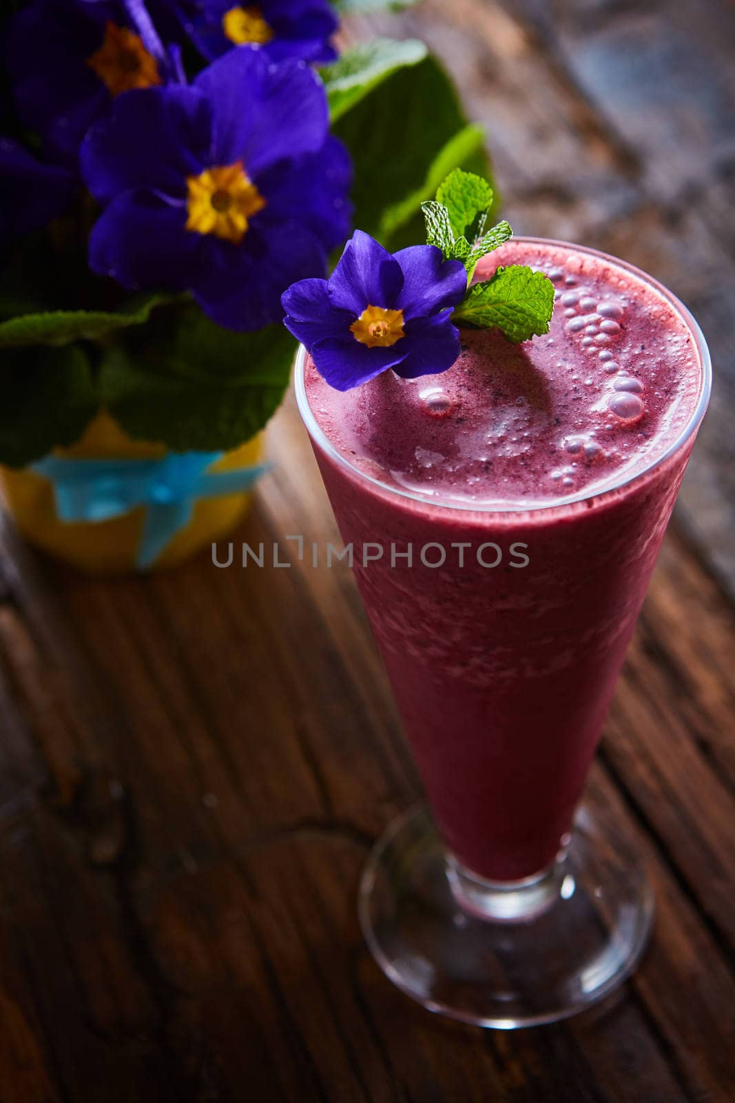 Delicious berry smoothie on table. The close-up