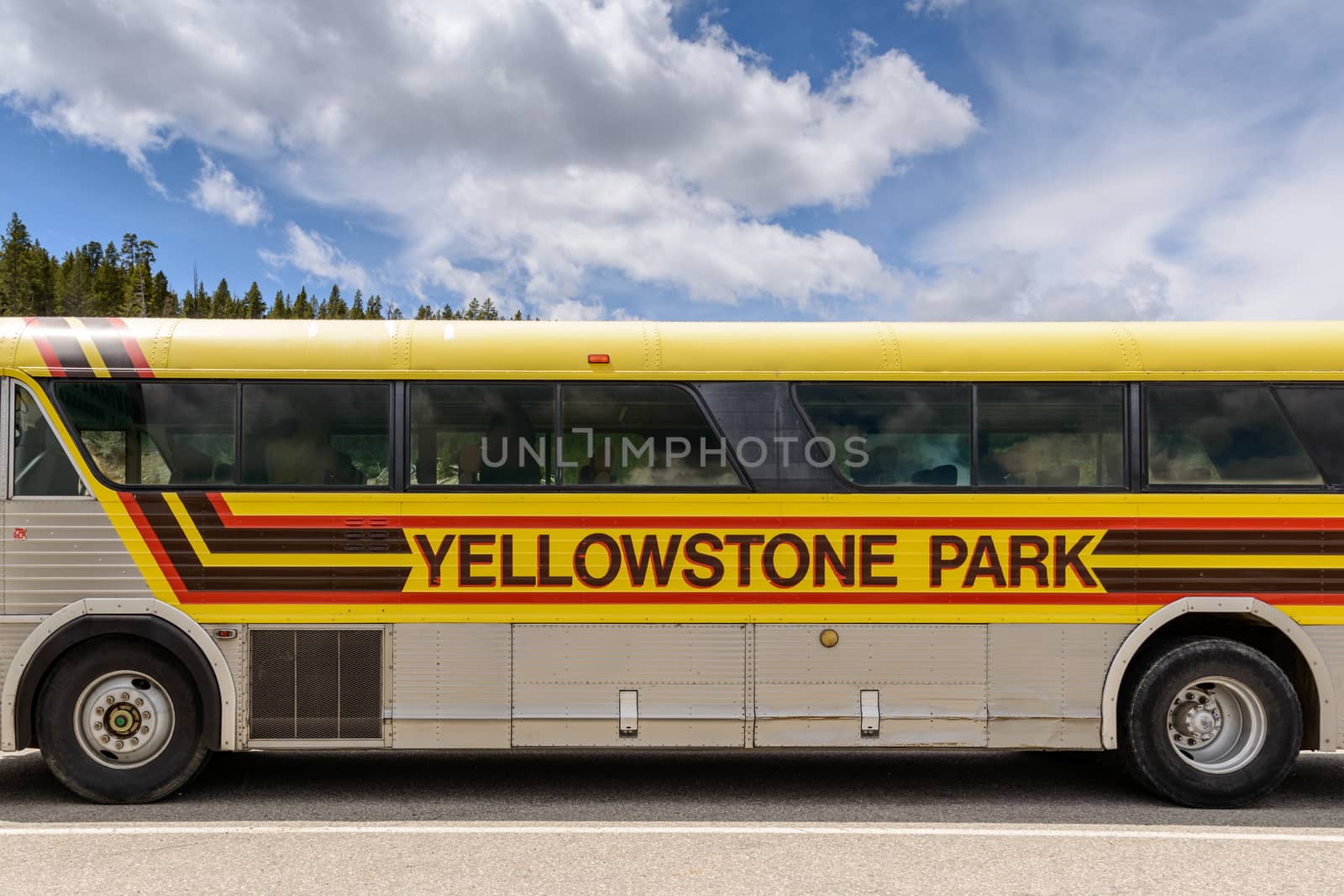 Yellowstone National Park, Wyoming, USA - May 31, 205: Close up of sign for Yellowstone Park on side of Tour Bus.Bus parked at the Mud Volcano Area on the Grand Loops Road in Yellowstone National Park in Wyoming.