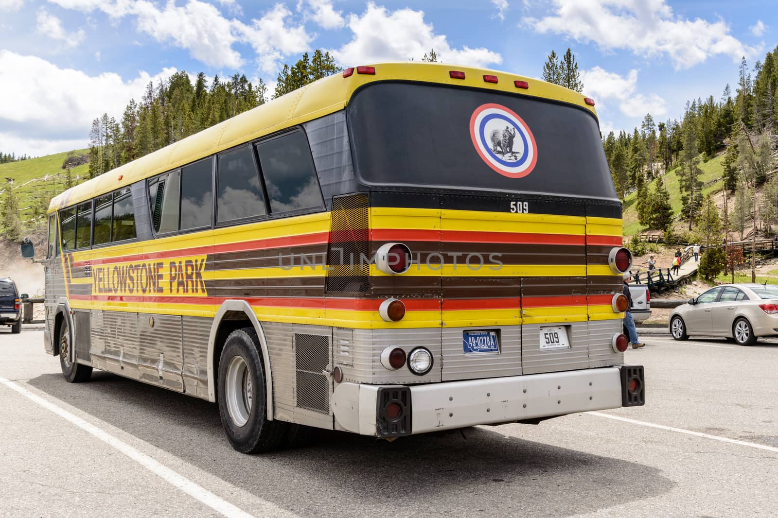 Yellowstone National Park, Wyoming, USA - May 31, 205: Tour of Yellowstone national park bus with side signs.Bus parked at the Mud Volcano Area on the Grand Loops Road in Yellowstone National Park in Wyoming.