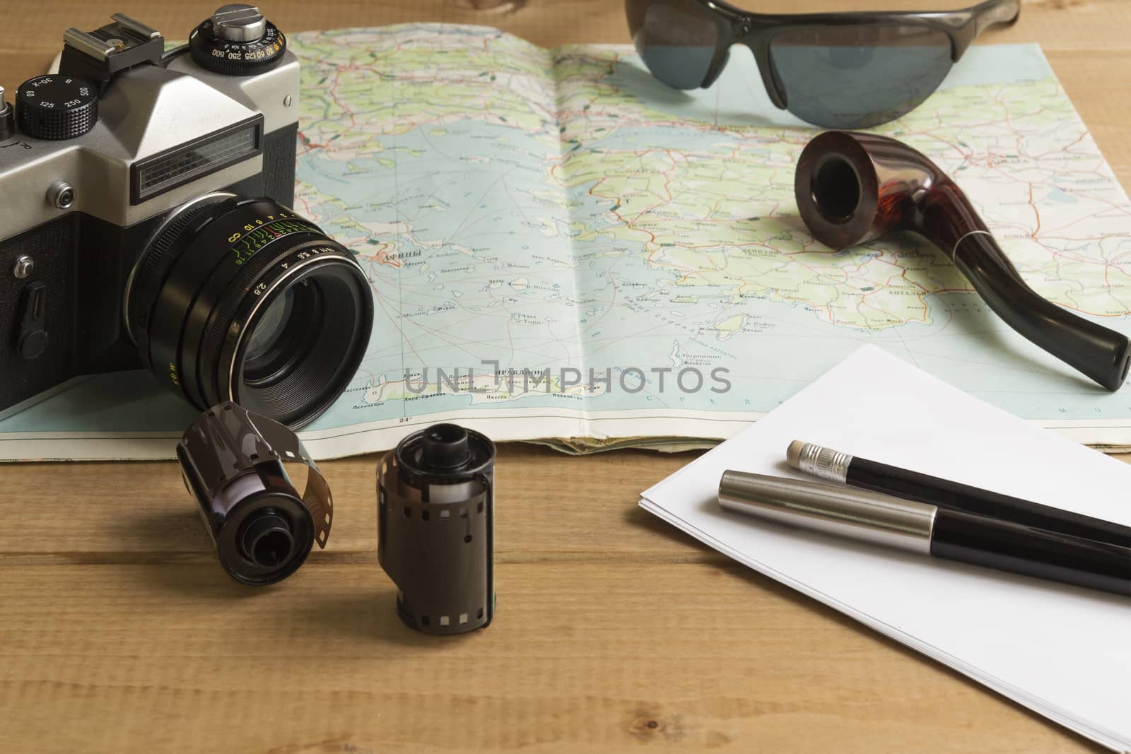 vintage camera and film on a map on the table