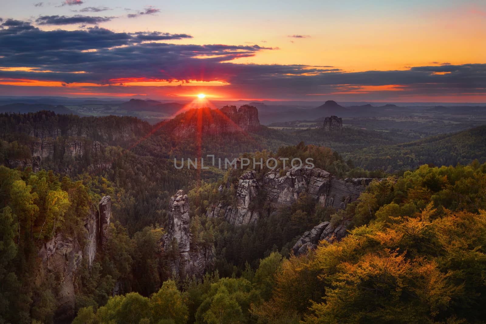 colorful sunset view on Schrammsteine from Carolafelsen in the national park Saxon Switzerland, Germany