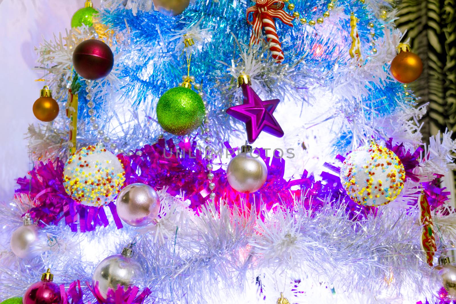 A white christmas tree decorated with colorful objects by stockbp