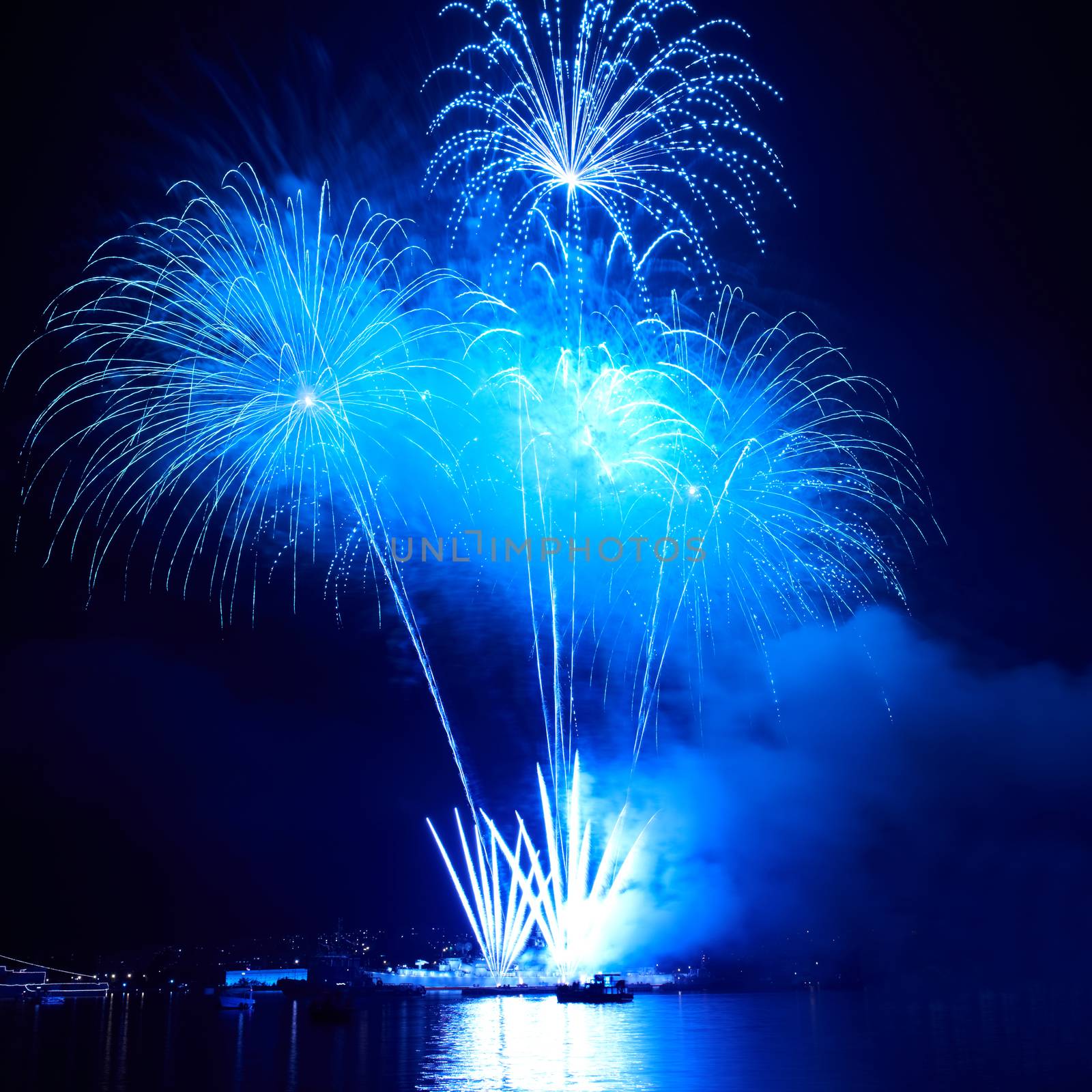 Blue colorful fireworks on the black sky background