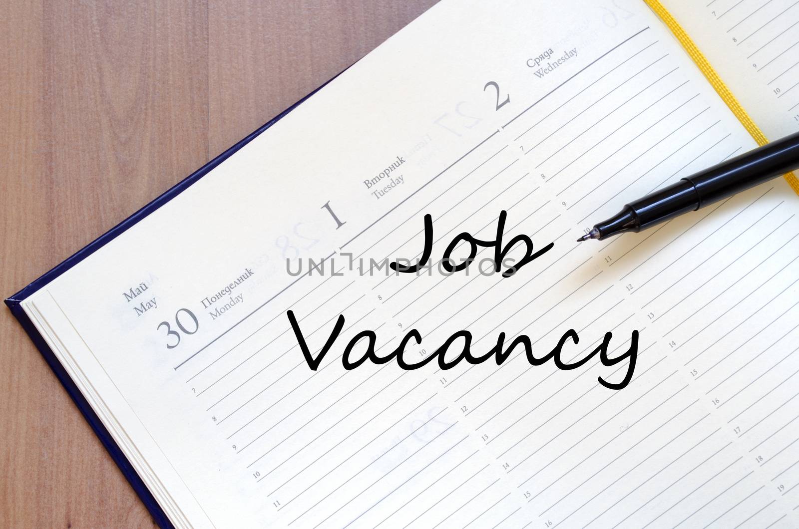 Job vacancy text concept write on notebook with pen