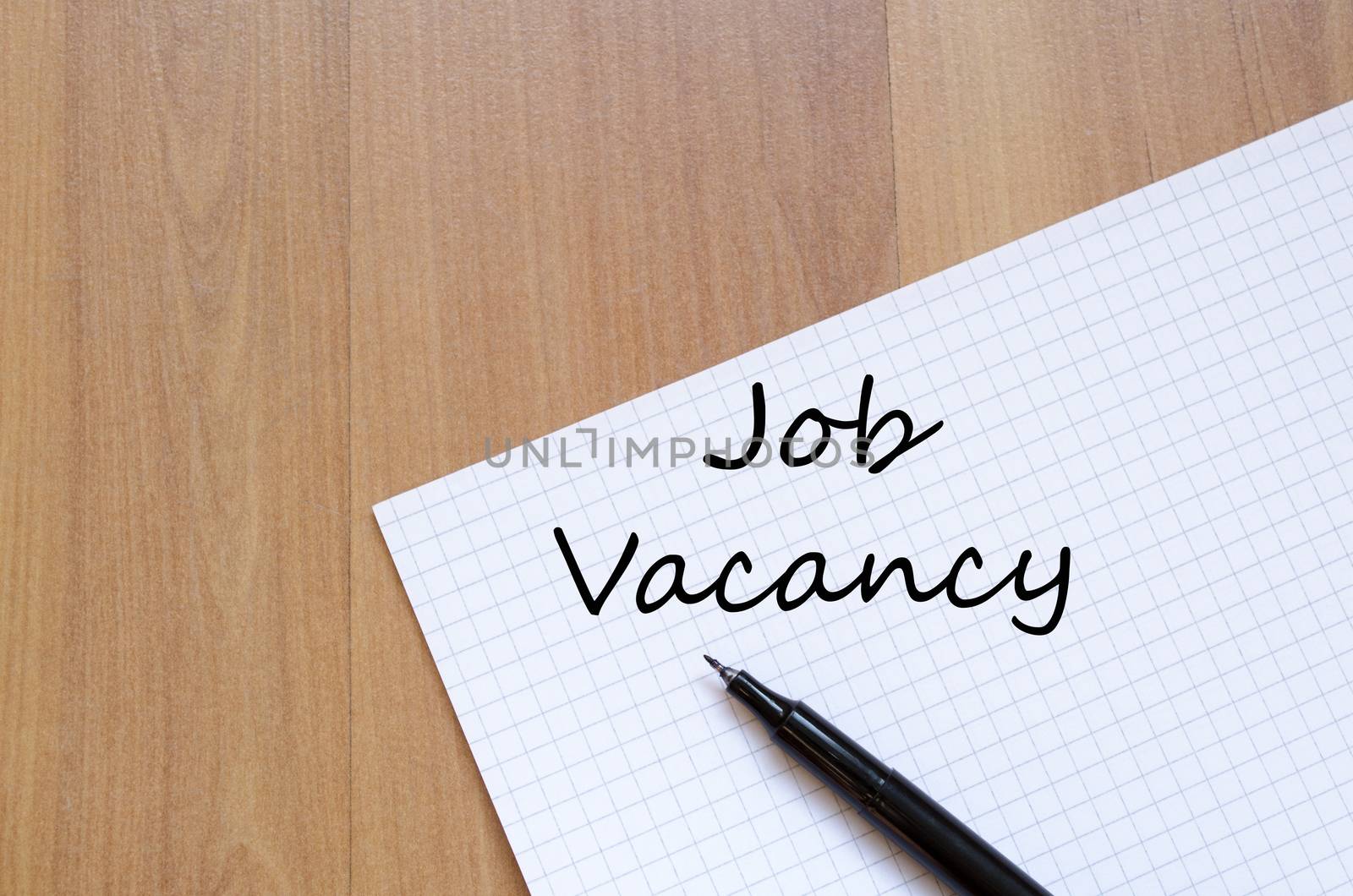 Job vacancy text concept write on notebook with pen