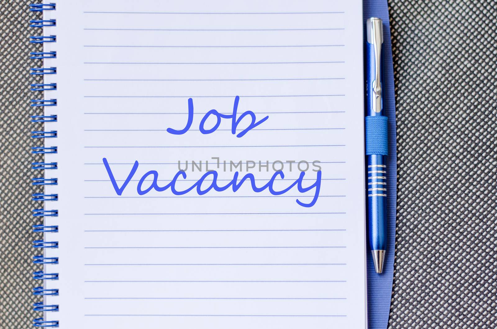 Job vacancy text concept write on notebook with pen