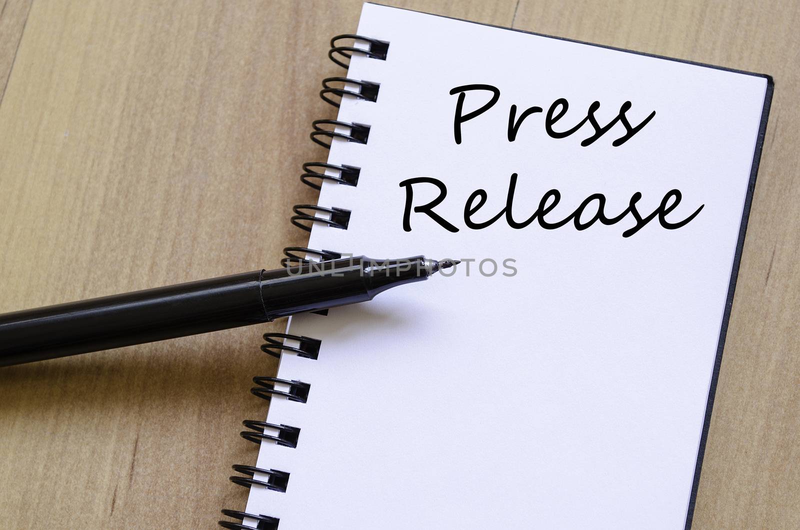 Press release text concept write on notebook with pen