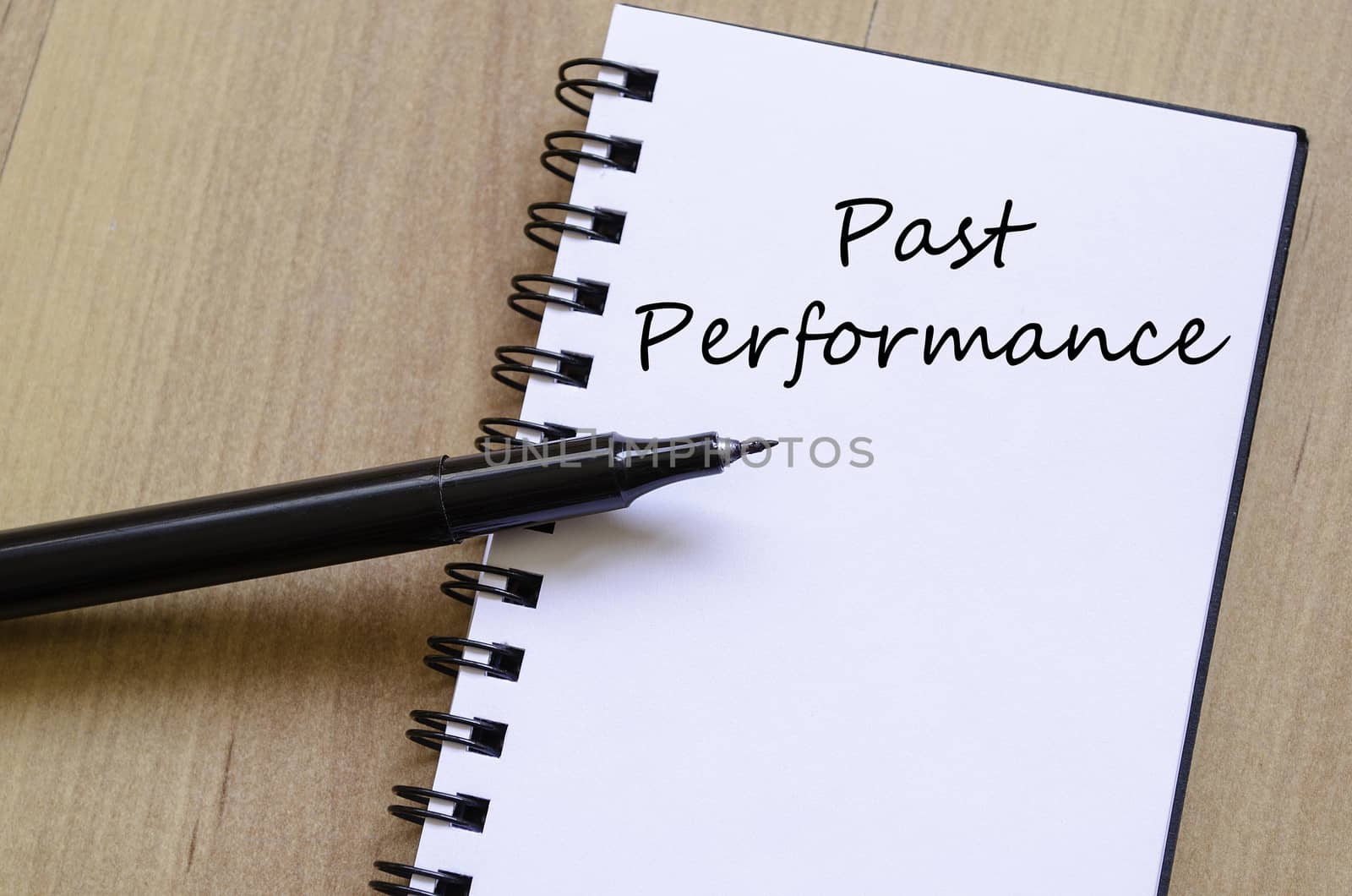 Past performance text concept write on notebook with pen