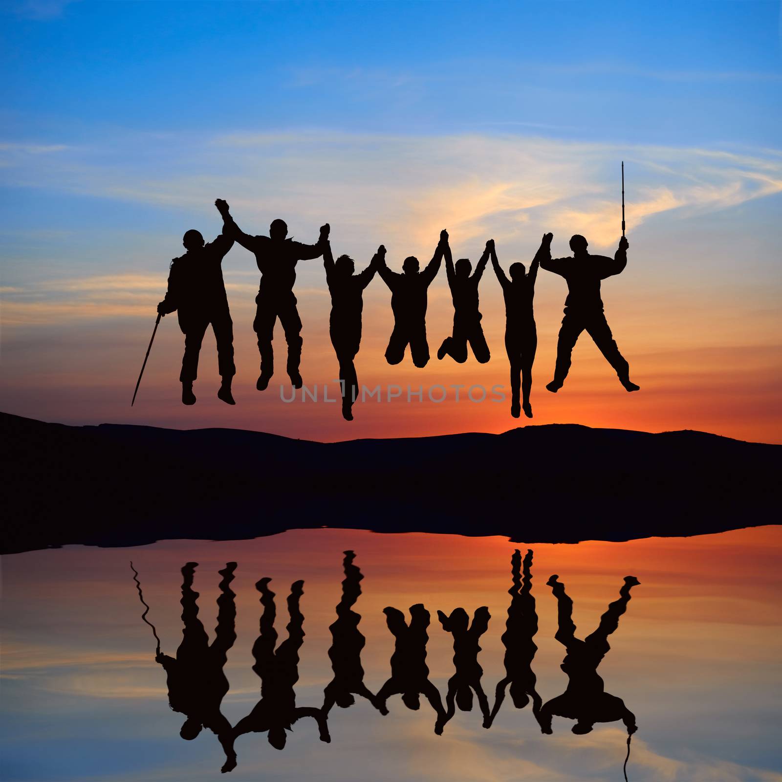 Silhouette of jumping friends on the beach with reflection against sunset