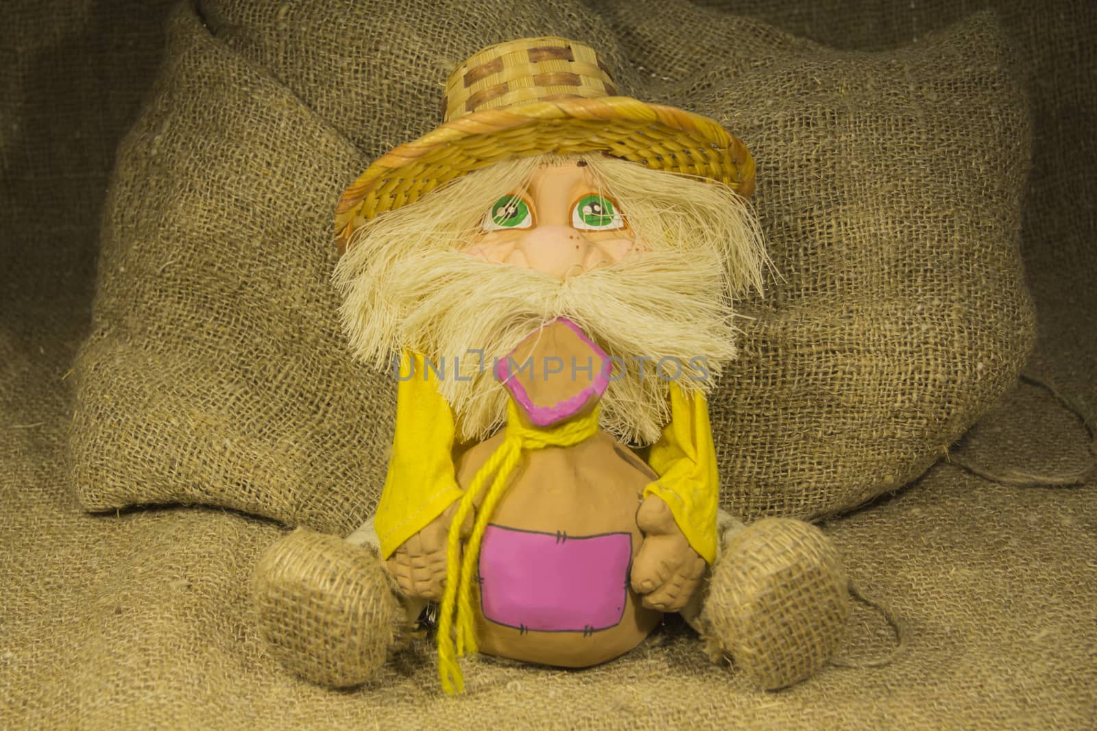 Toy House spirit in a straw hat keeps bag