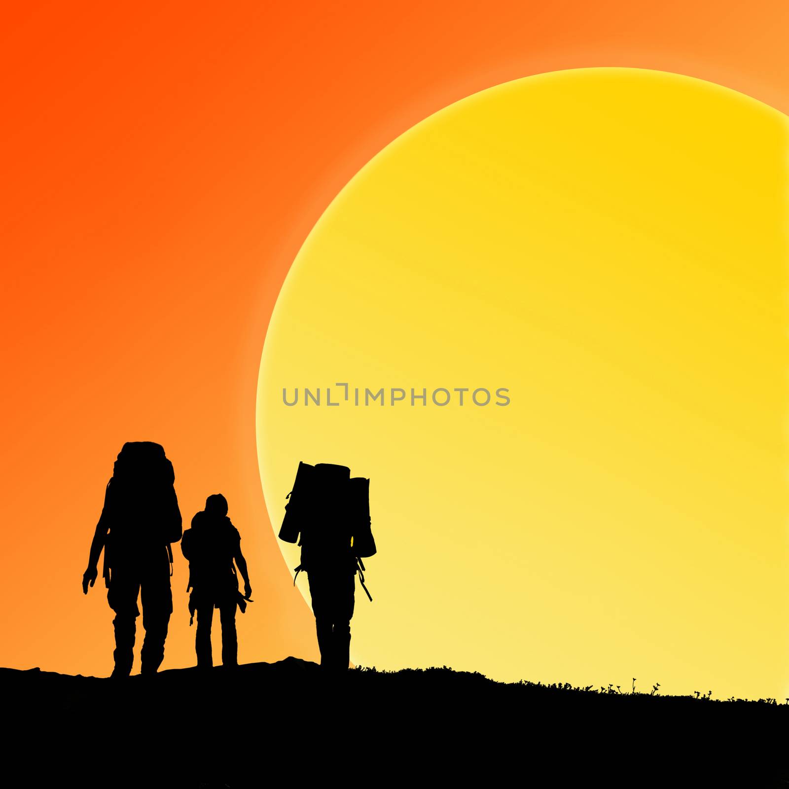 Silhouette of hiking friends against sunset and big sun