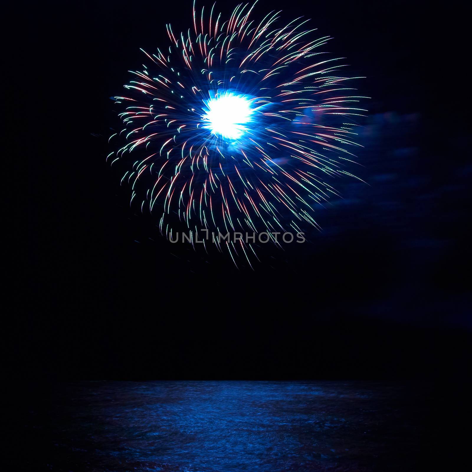 Blue and red colorful holiday fireworks on the black sky background.