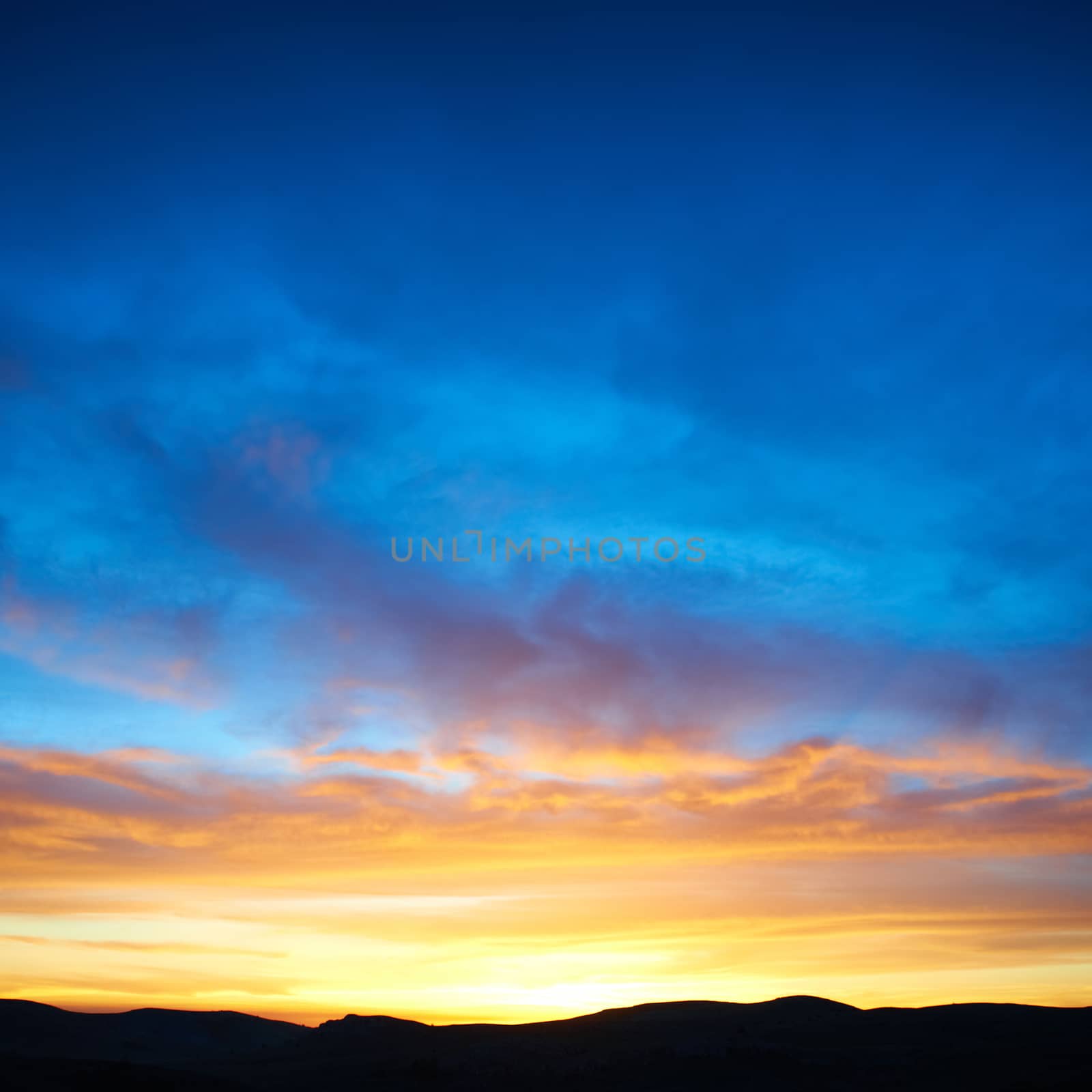 Land with and dramatic colorful sky at sunset