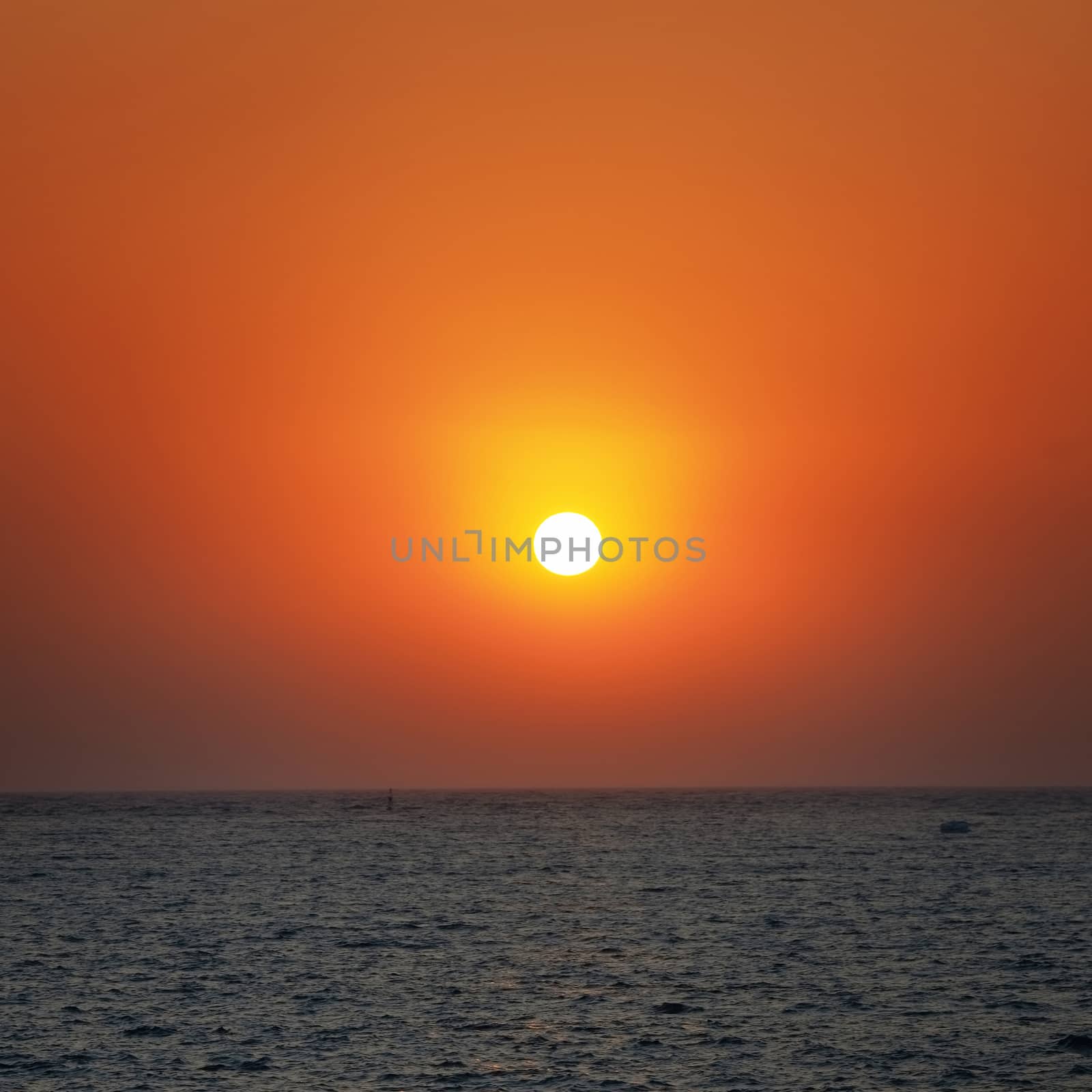 Beautiful orange sunset on the sea with shining sun