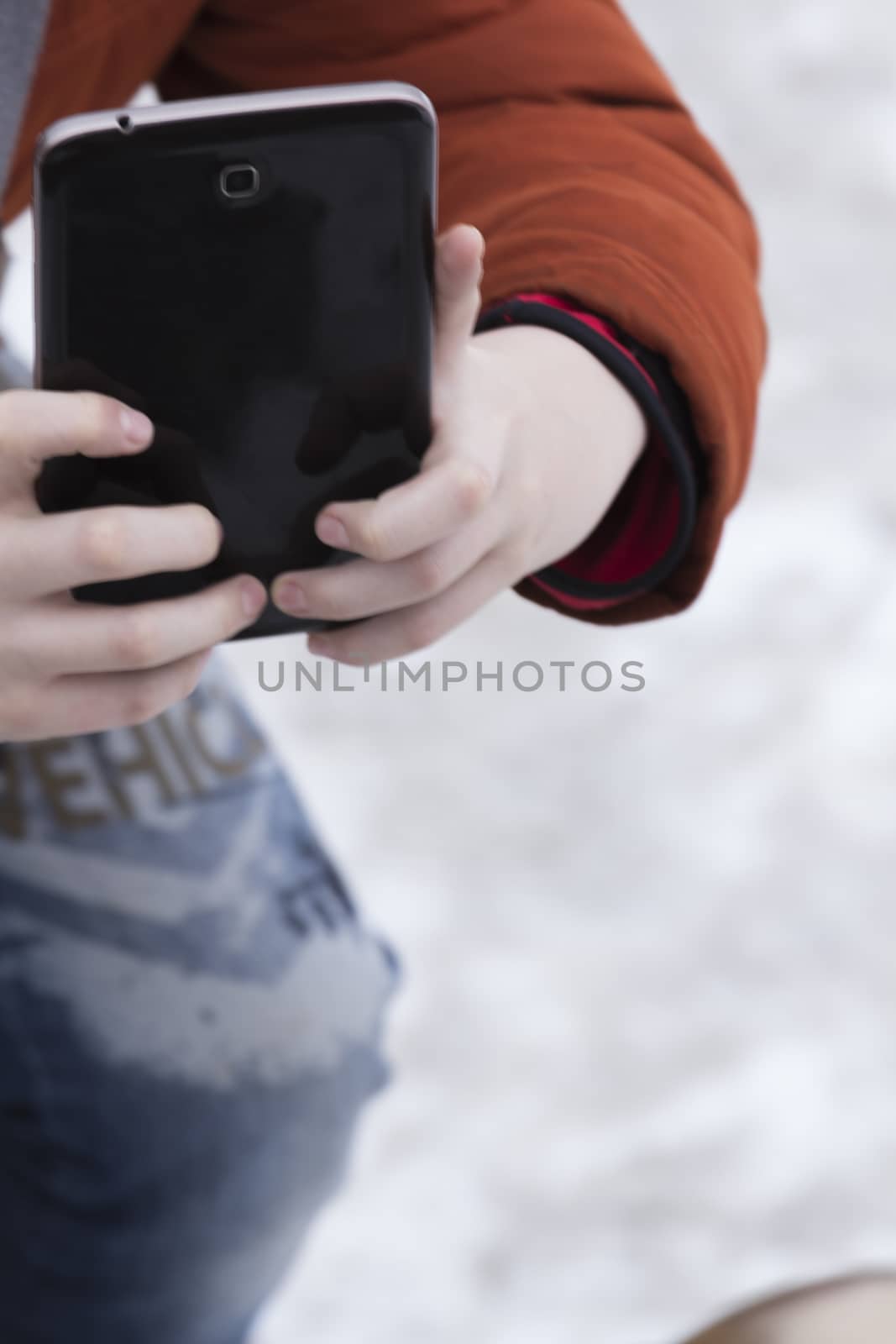 the young man takes pictures on a mobile phone