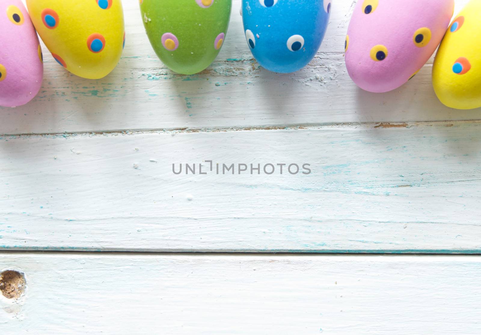 Easter eggs on wooden background by unikpix