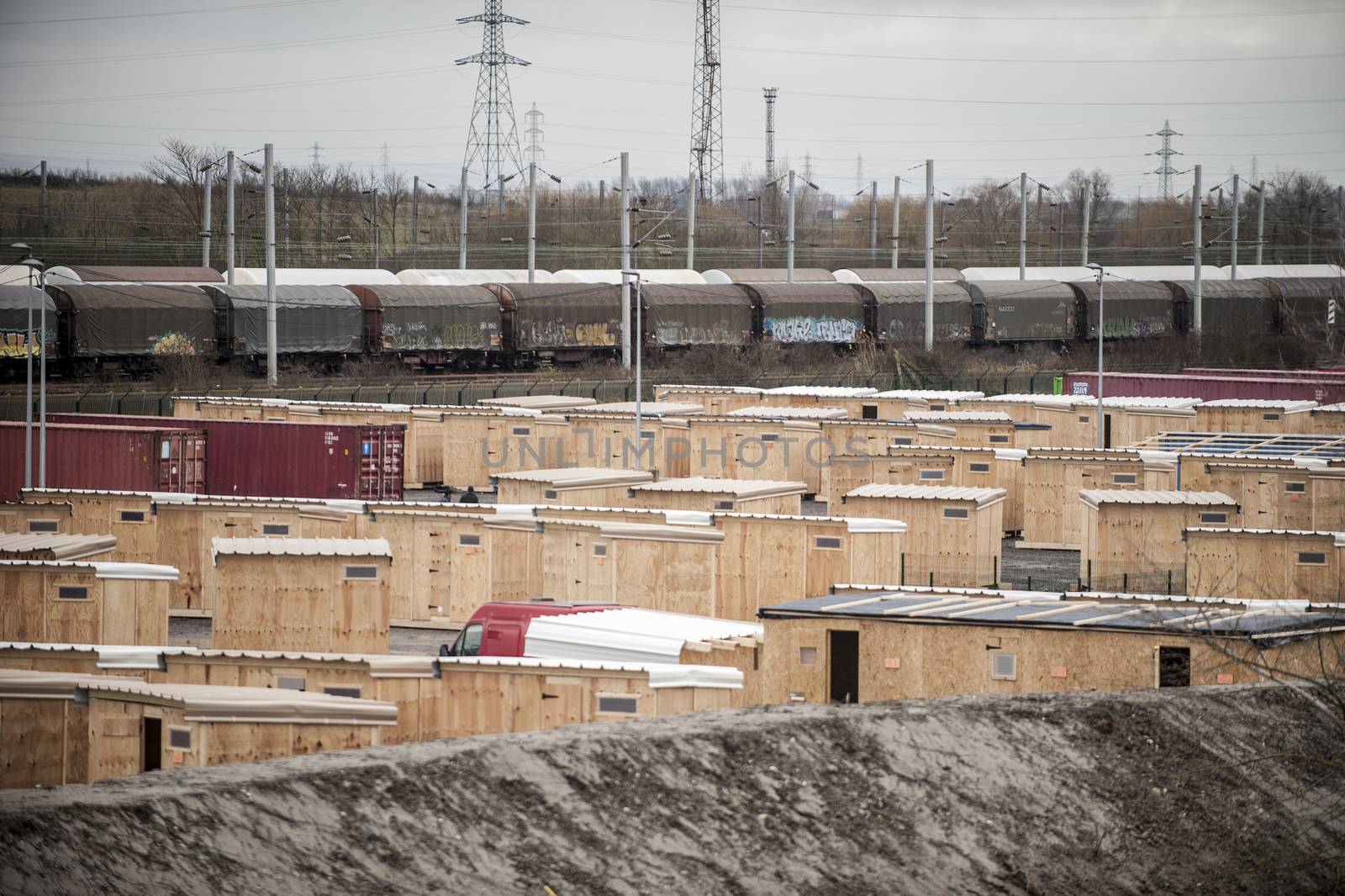 FRANCE, Grande-Synthe: Dozens of new wooden structures are pictured at the new camp at Grande Synthe on March 7, 2016.The new camp features make shift shelters to provide more protection from the elements. Also available are better sanitation measures including showers and toilets.  