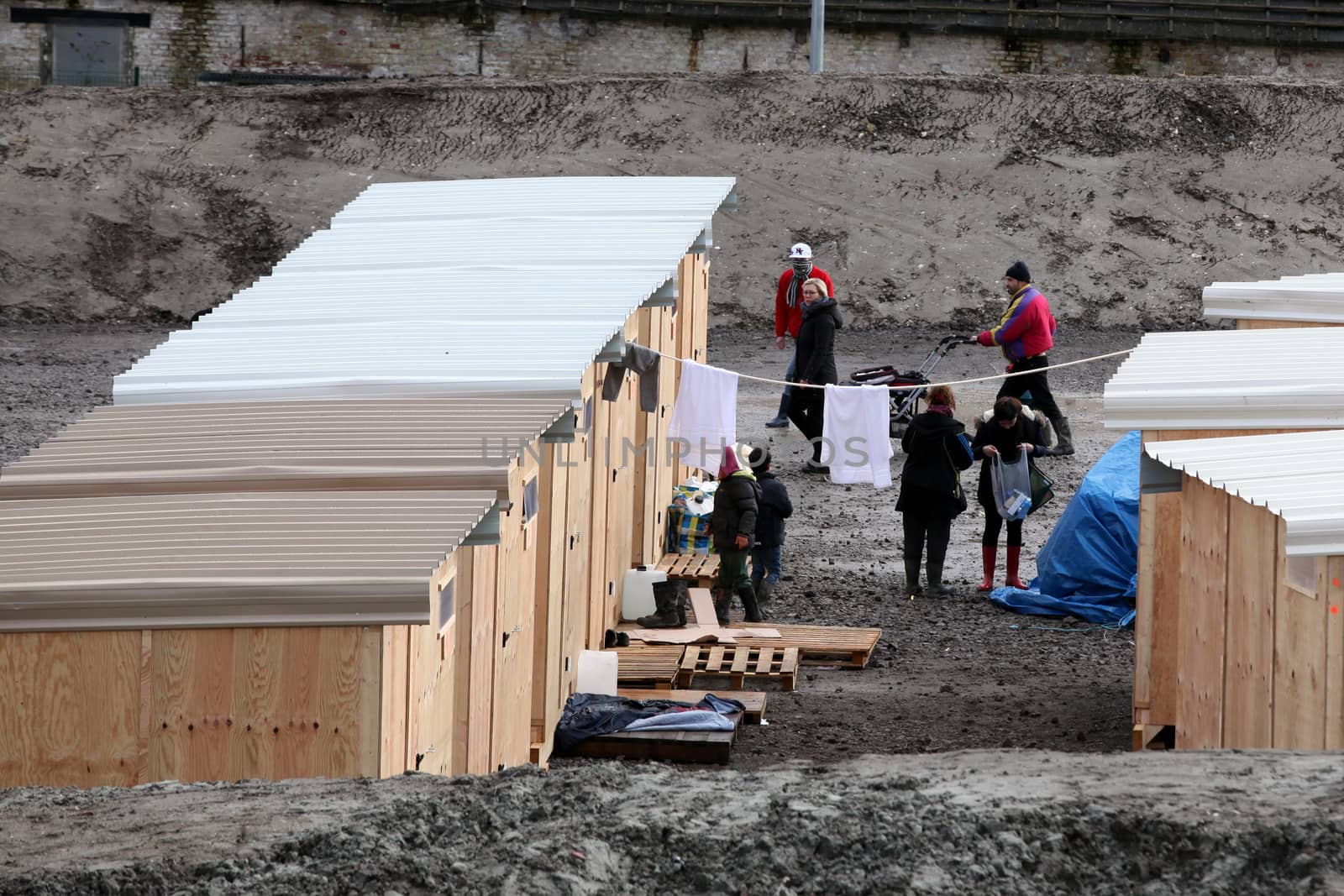 FRANCE, Grande-Synthe: Migrants and refugees arrive in the first international-standard refugee camp on March 7, 2016 in Grande-Synthe, northern France.France opened its first international-standard refugee camp in the teeth of official opposition on March 7 while demolition continued at the nearby Calais Jungle camp. The new camp, featuring some 200 heated wooden cabins and proper toilets and showers, has been built by Doctors Without Borders (MSF) with the support of the local town hall, despite opposition from the French government.