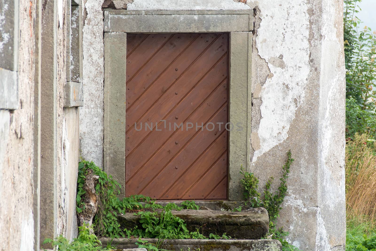 Old wooden door with stone frames
