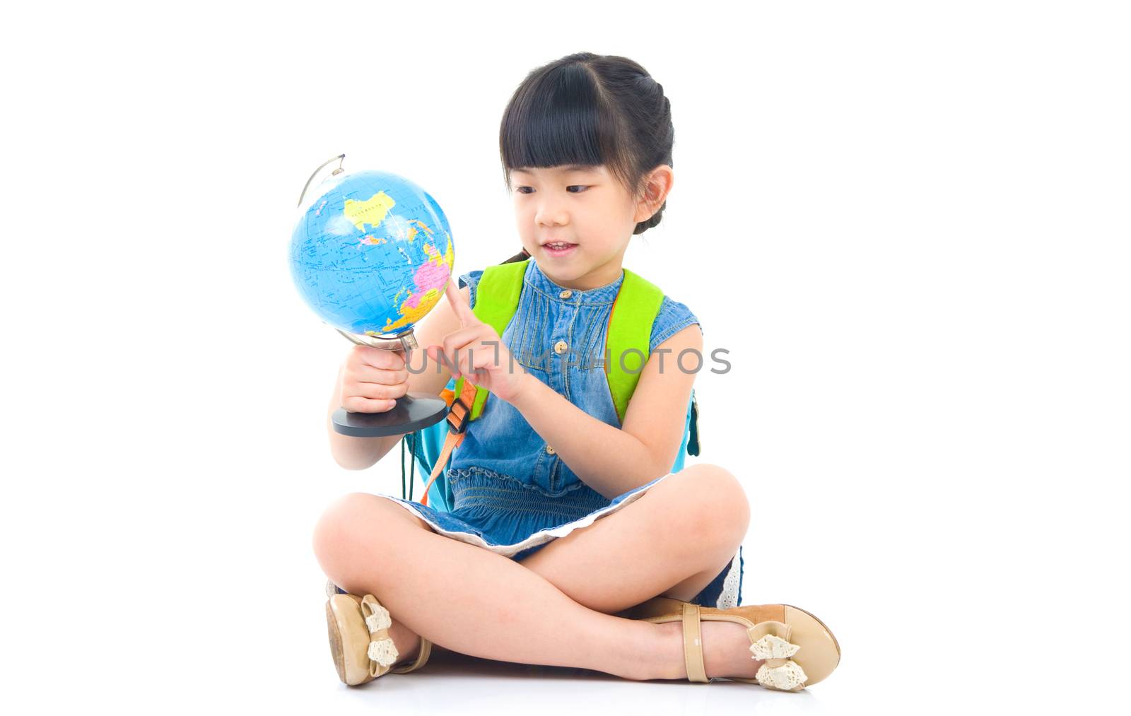 Asian cute girl looking at the globe