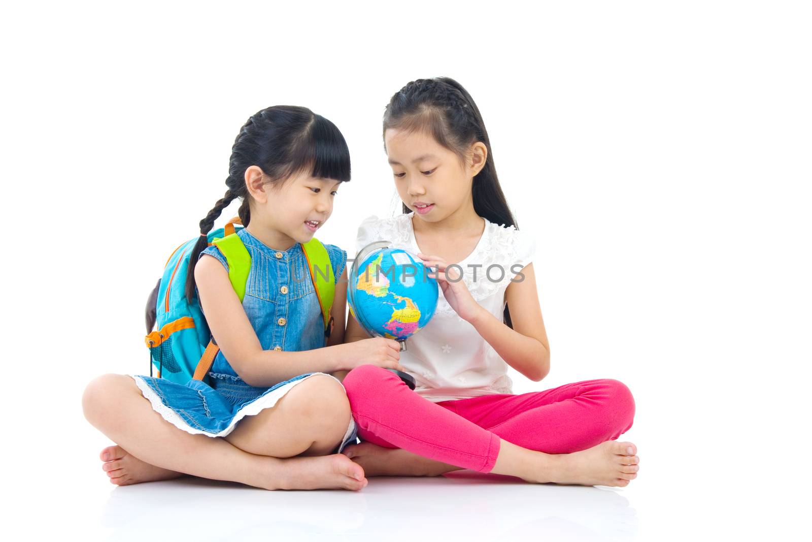 Asian kids looking at the globe