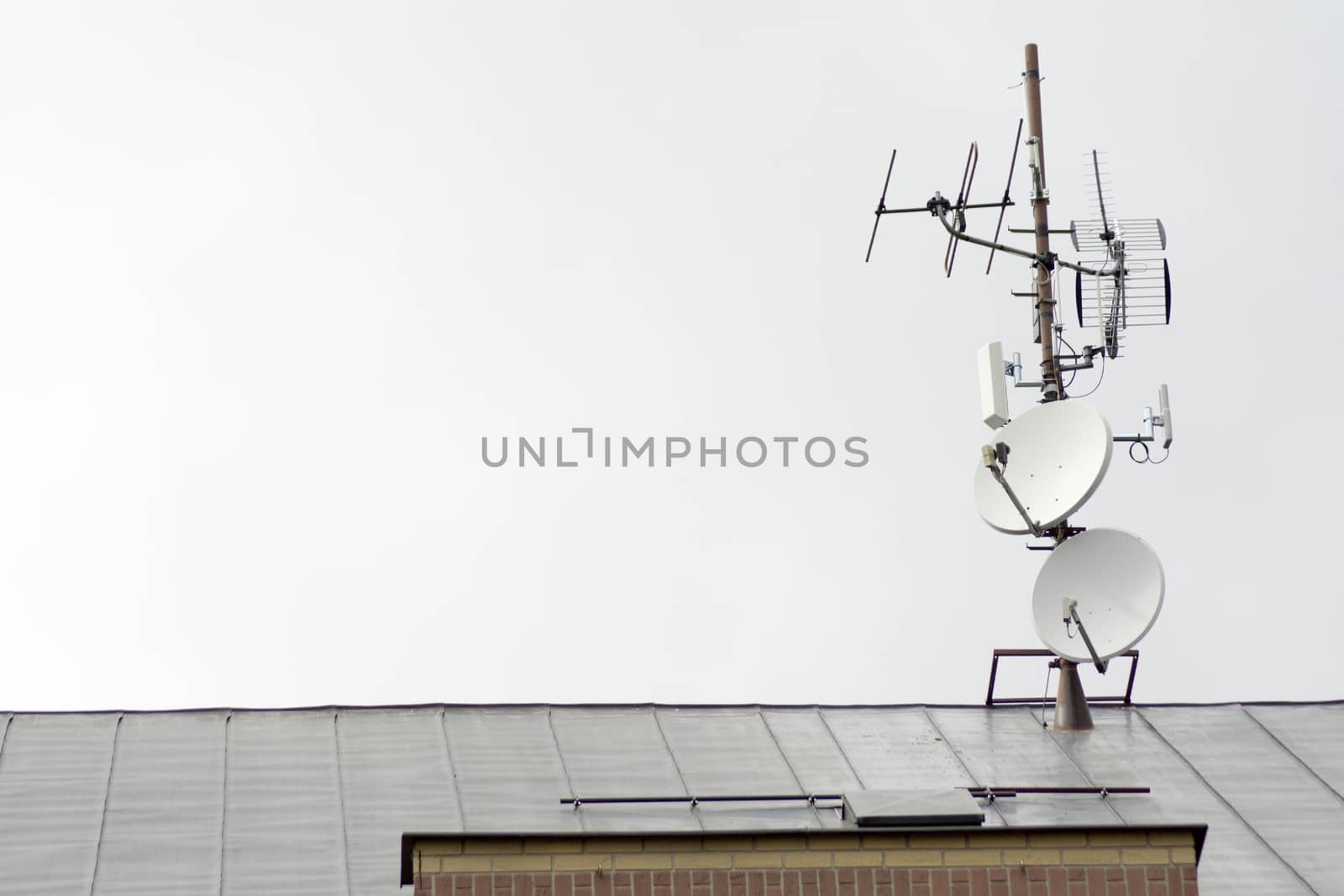 TV antennas and satellites on the roof of the house
