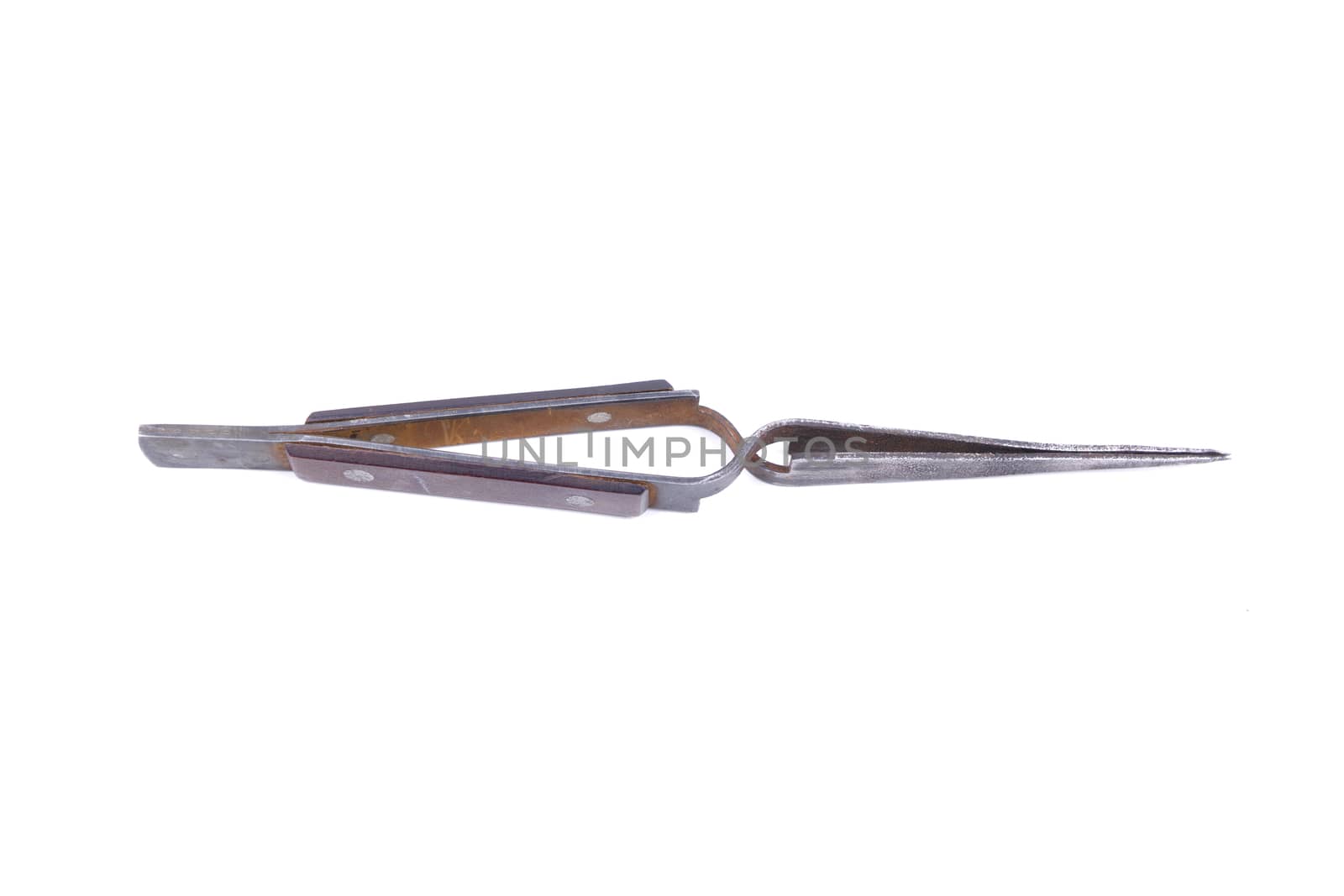 Old metal tweezers isolated on a white background