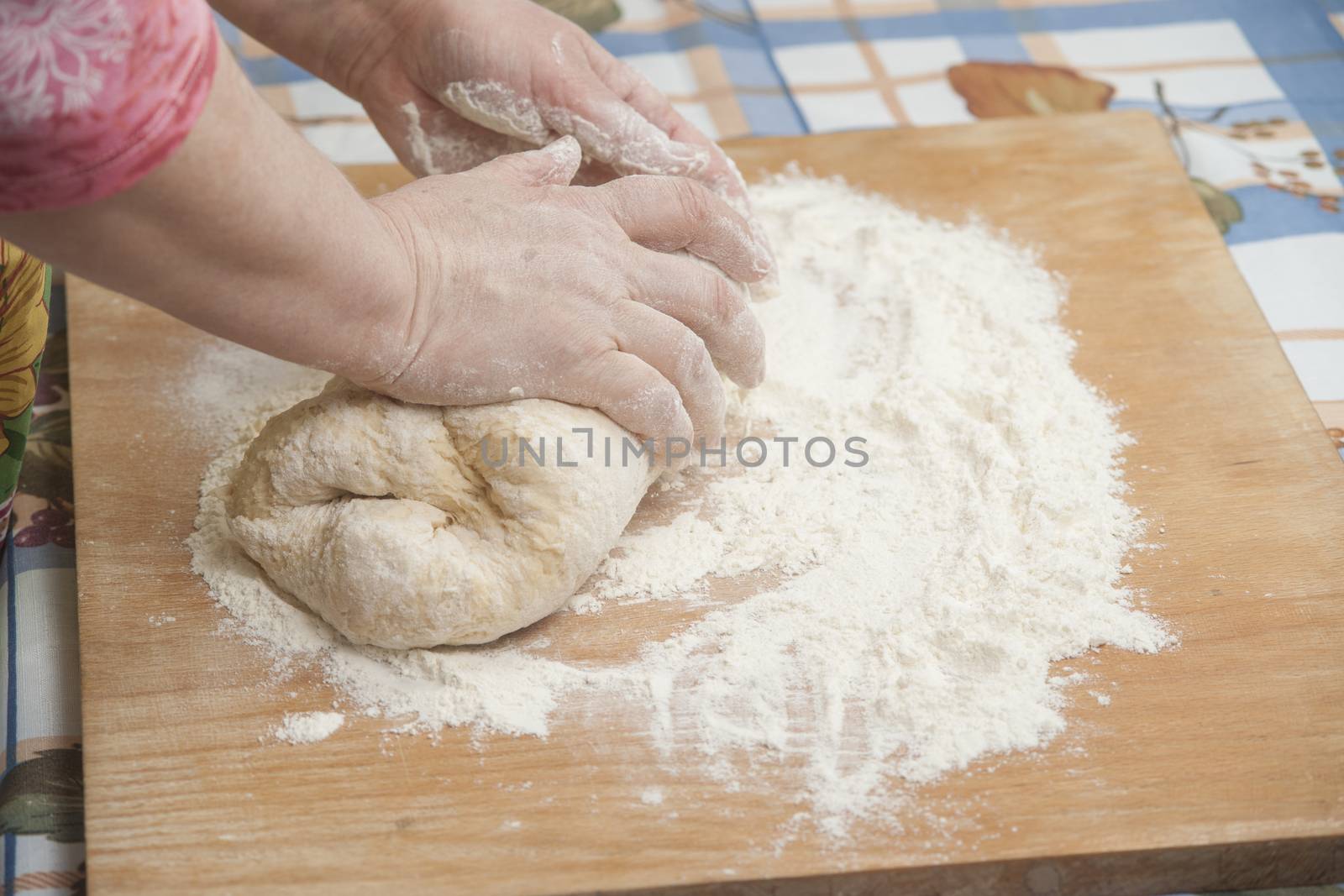 Women's hands prepairing fresh yeast dough by kozak