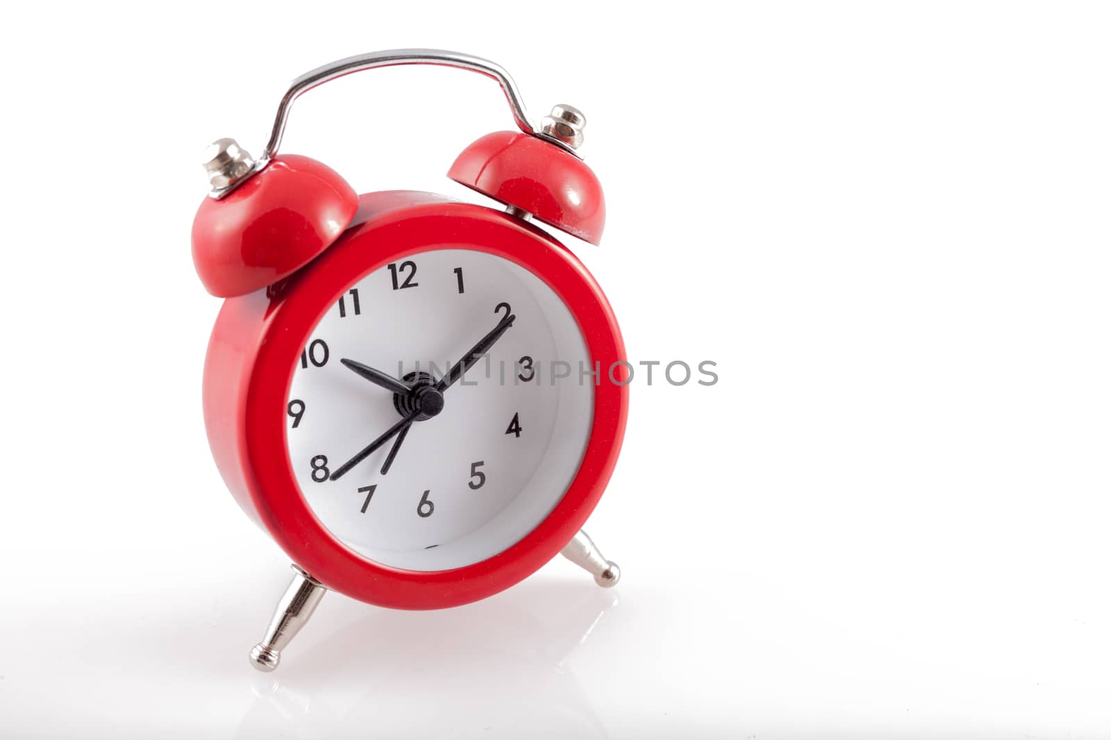 Alarm Clock. Classic red old style alarm clock isolated on white