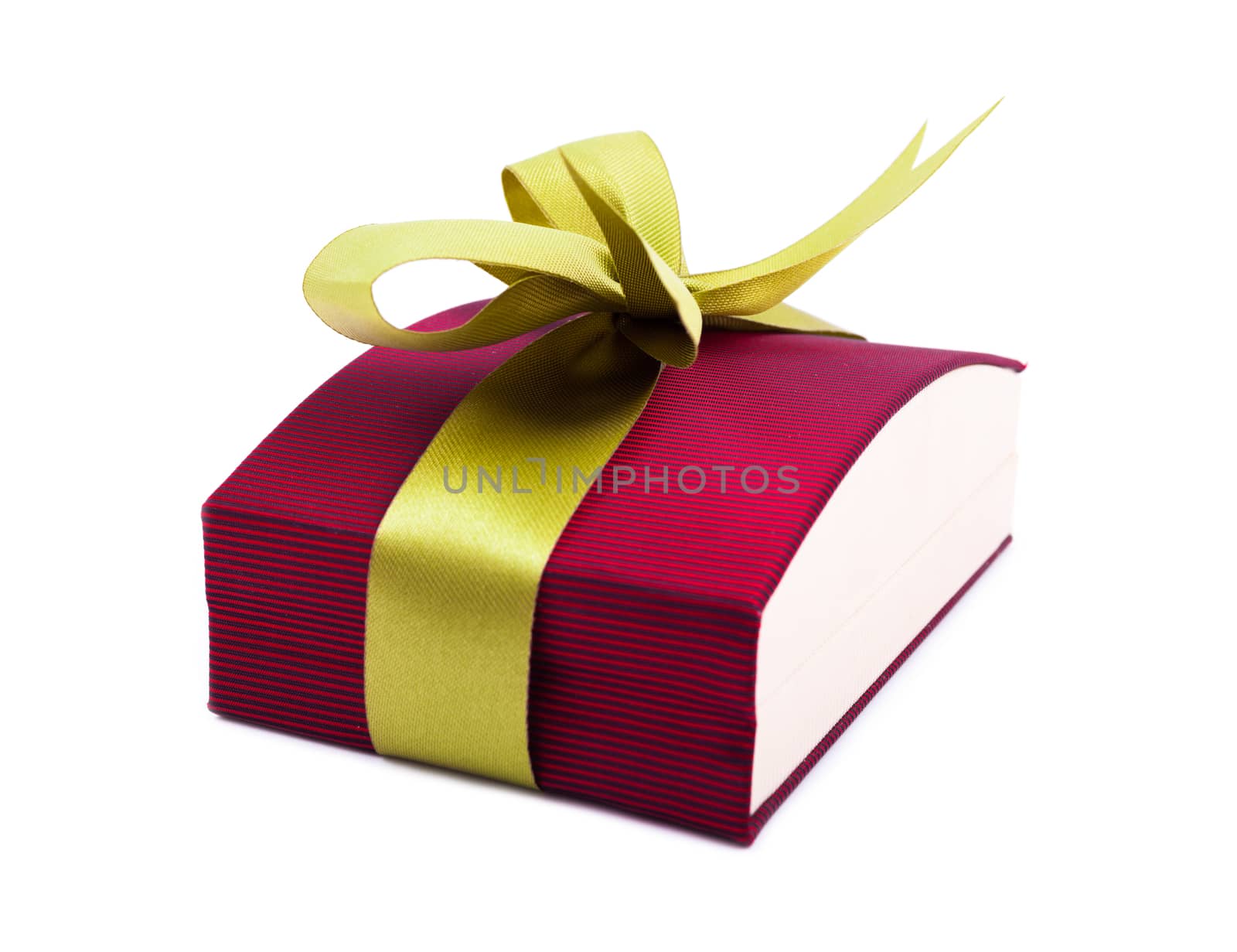 Luxury gift box in dark red shades with green satin ribbon and bow isolated over white background.