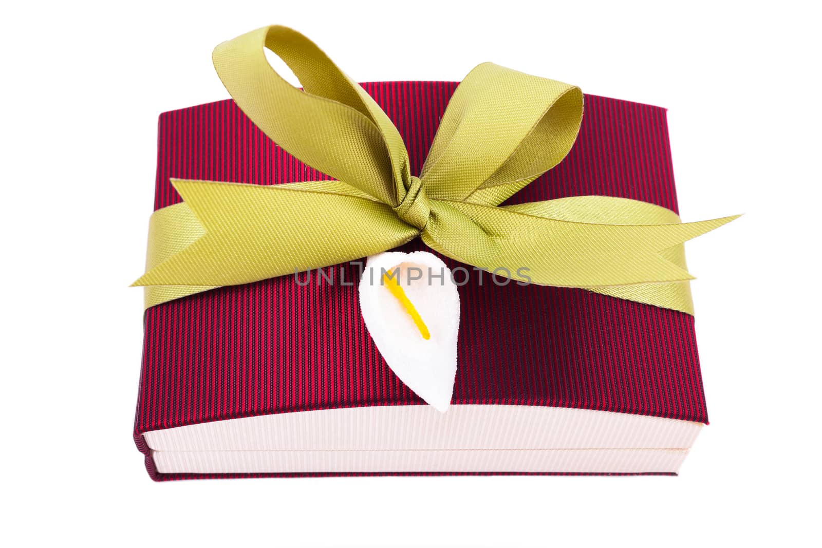 Luxury gift box in dark red shades with green satin ribbon and bow isolated over white background.