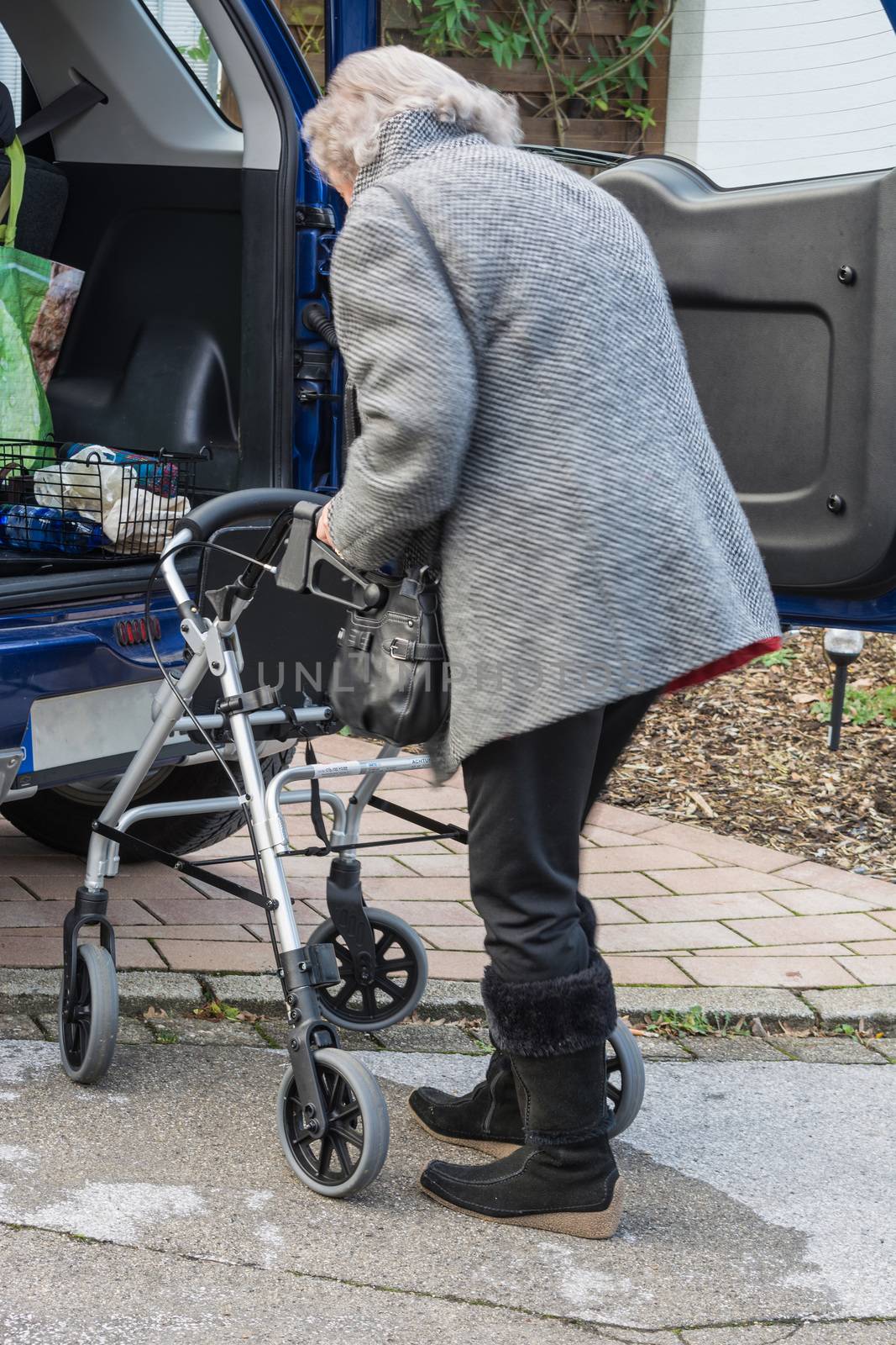 Elderly lady with Walking frame on the car       by JFsPic