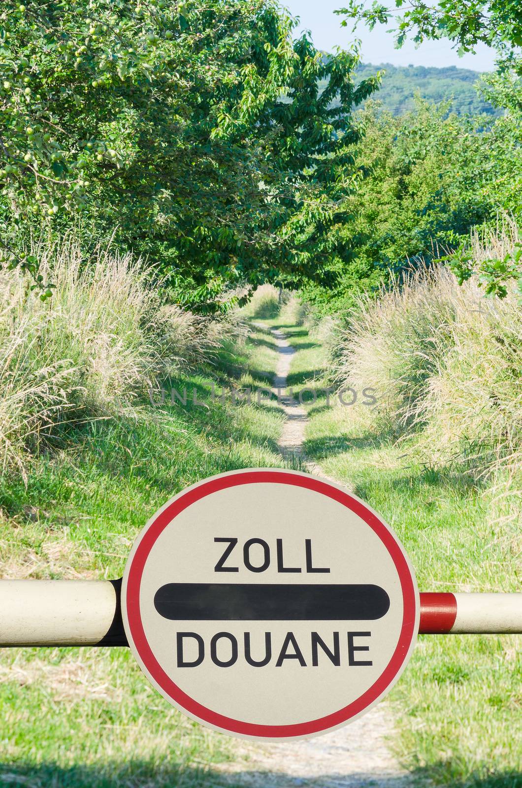 Tollgate with demarcation and road sign customs office between two countries.