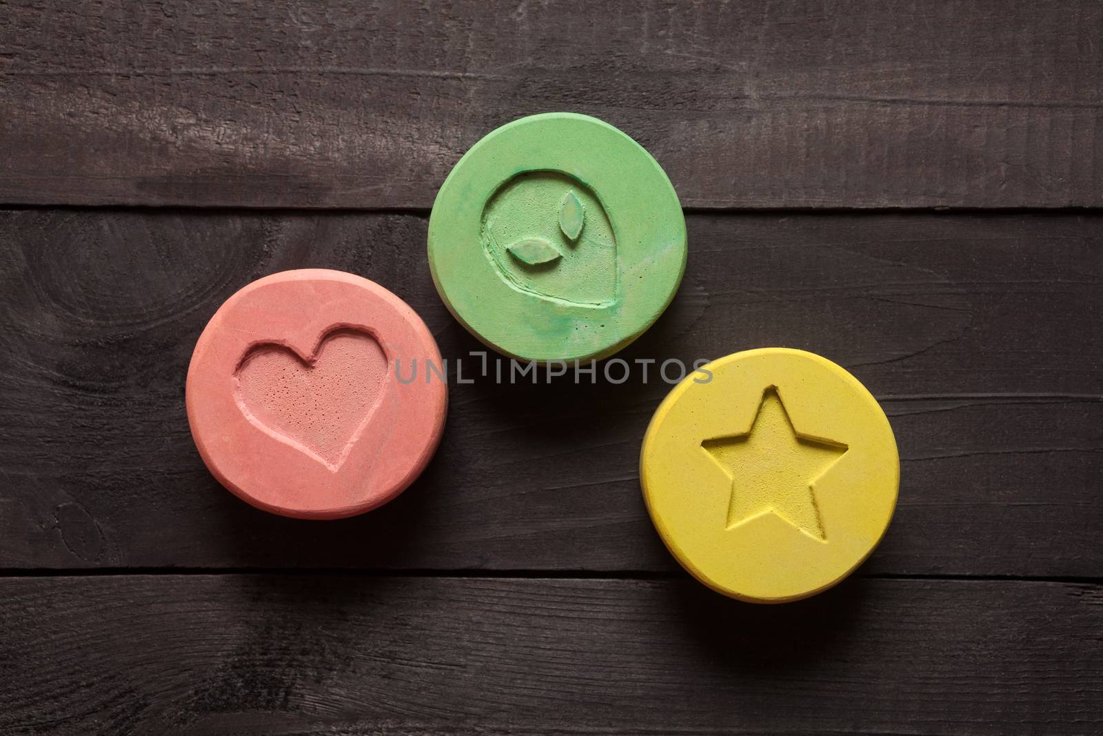 Ecstasy tablets on black background