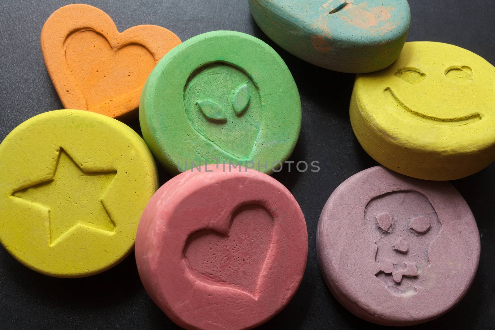 Ecstasy tablets on black background