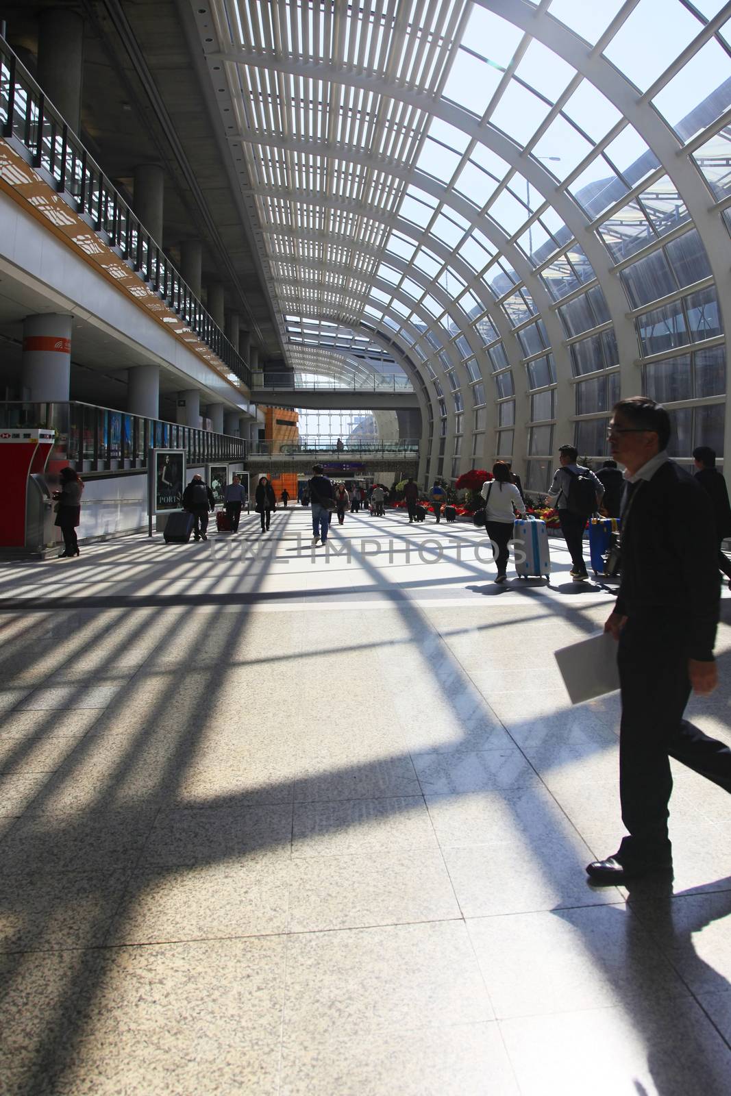 Hong Kong, Hong Kong S.A.R. - December 29, 2014: Passengers in the airport main lobby in Hong Kong, China. The Hong Kong airport handles more than 70 million passengers per year.