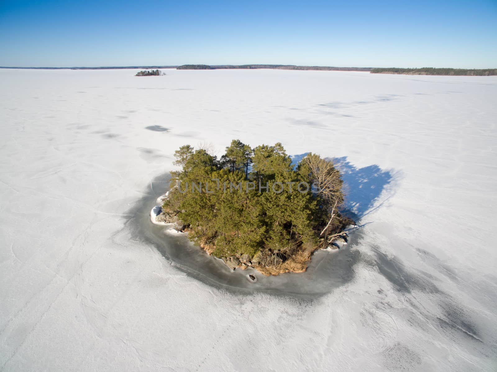 Island surronded by ice on a frozen lake