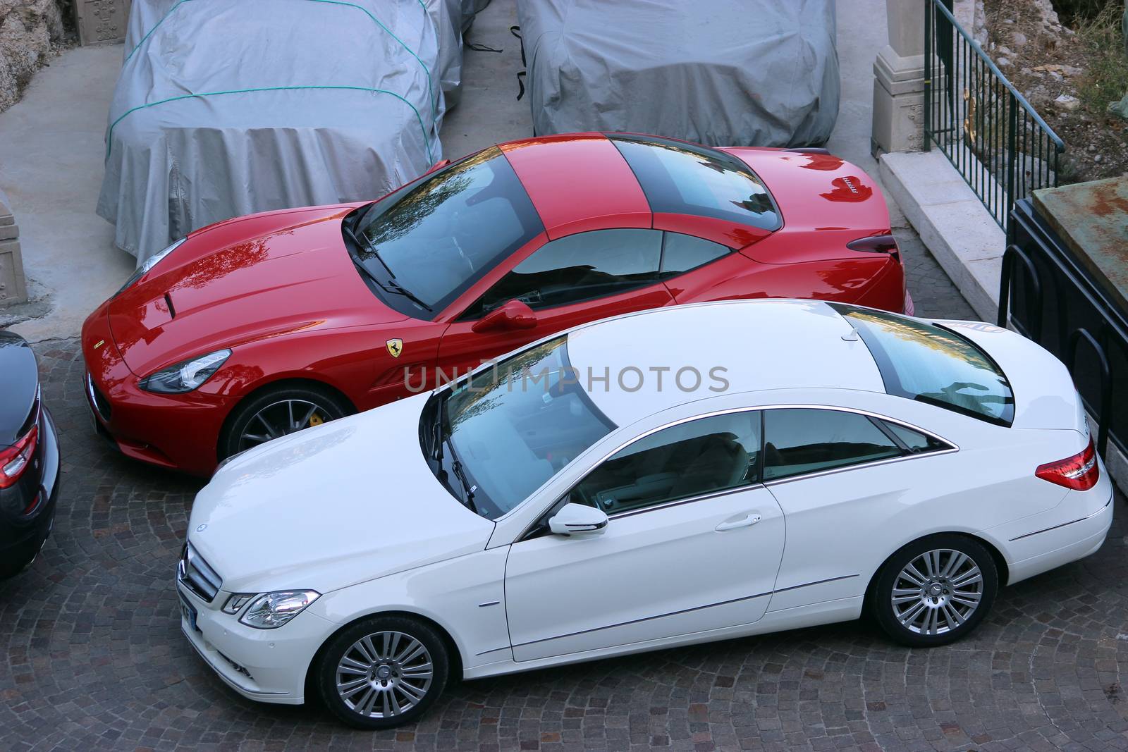 Eze, France - August 30, 2015: Luxury Cars (Mercedes and Ferrari) Parked in a Parking Lot of a 5 star Hotel in Eze. Commune in the Alpes-Maritimes department in Southeastern France