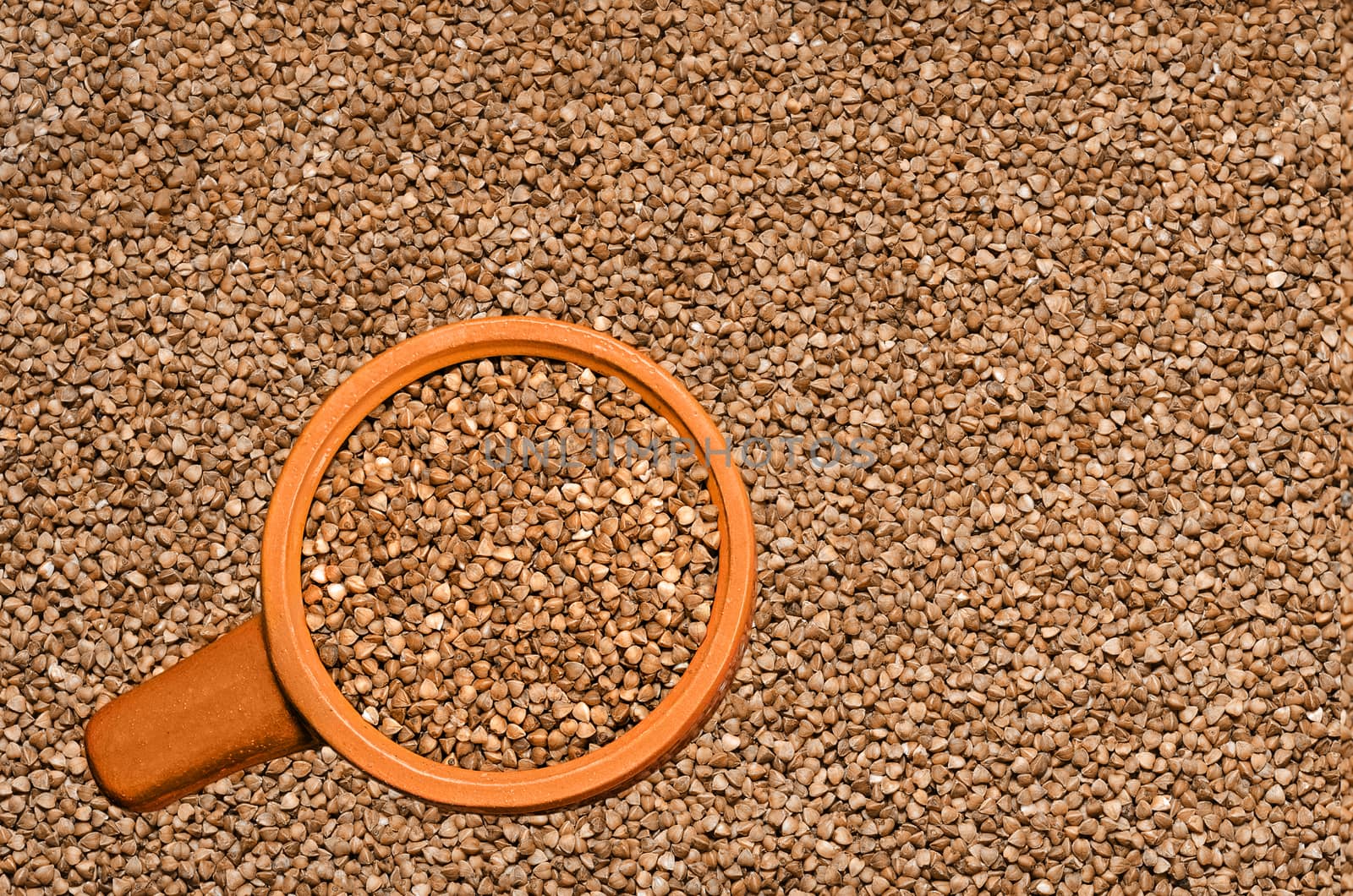 Textures background of buckwheat, and buckwheat in a ceramic Cup