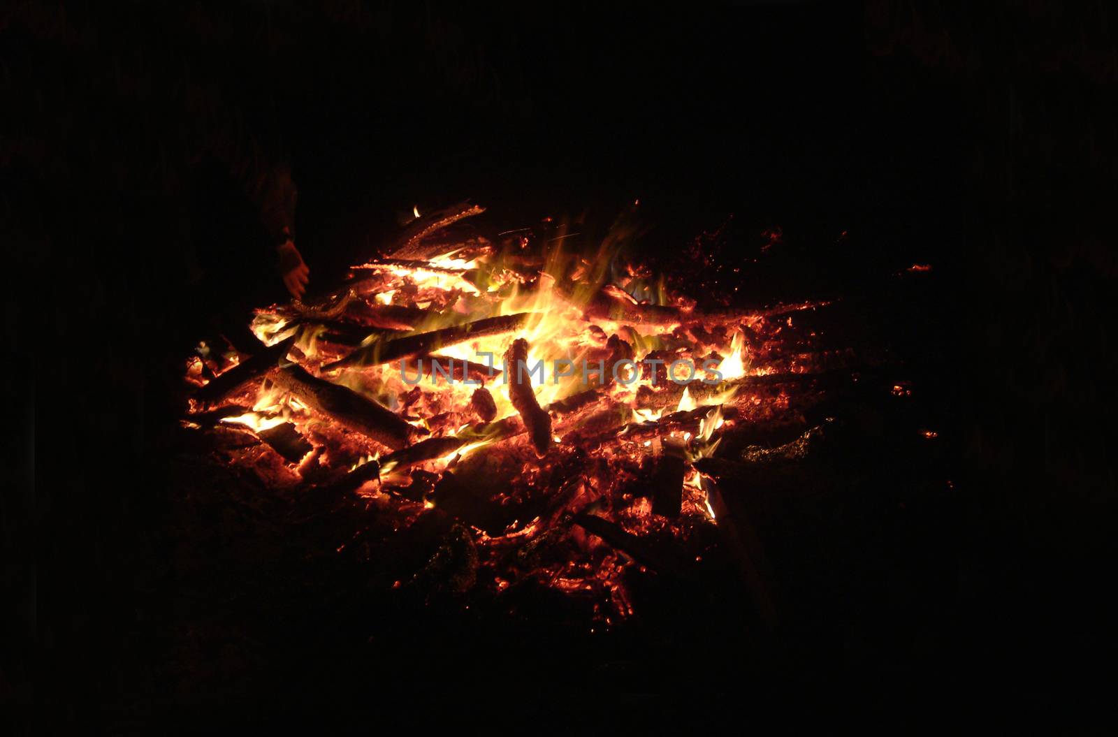 The dying embers of a camp fire