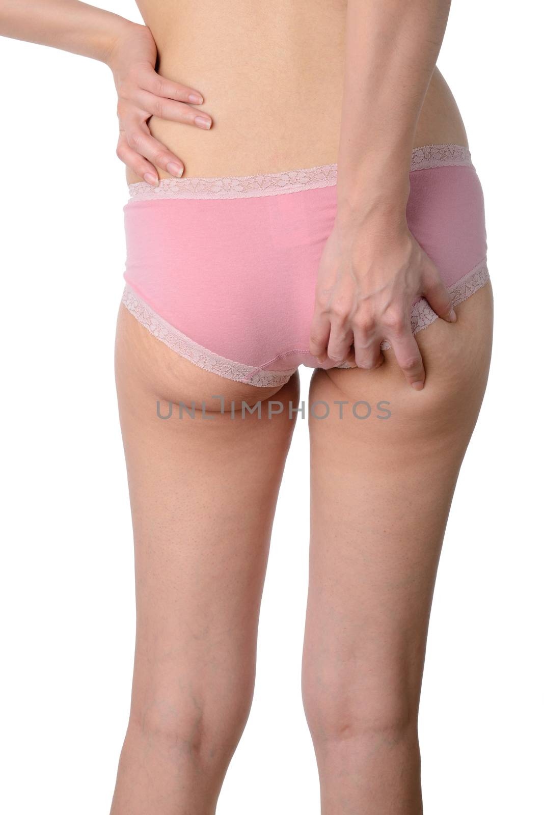 Slim woman checking her fat and cellulite on buttocks isolated o by numskyman