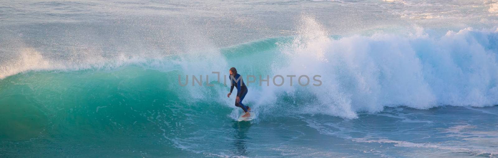 Senior surfer riding a perfect wave. by kasto